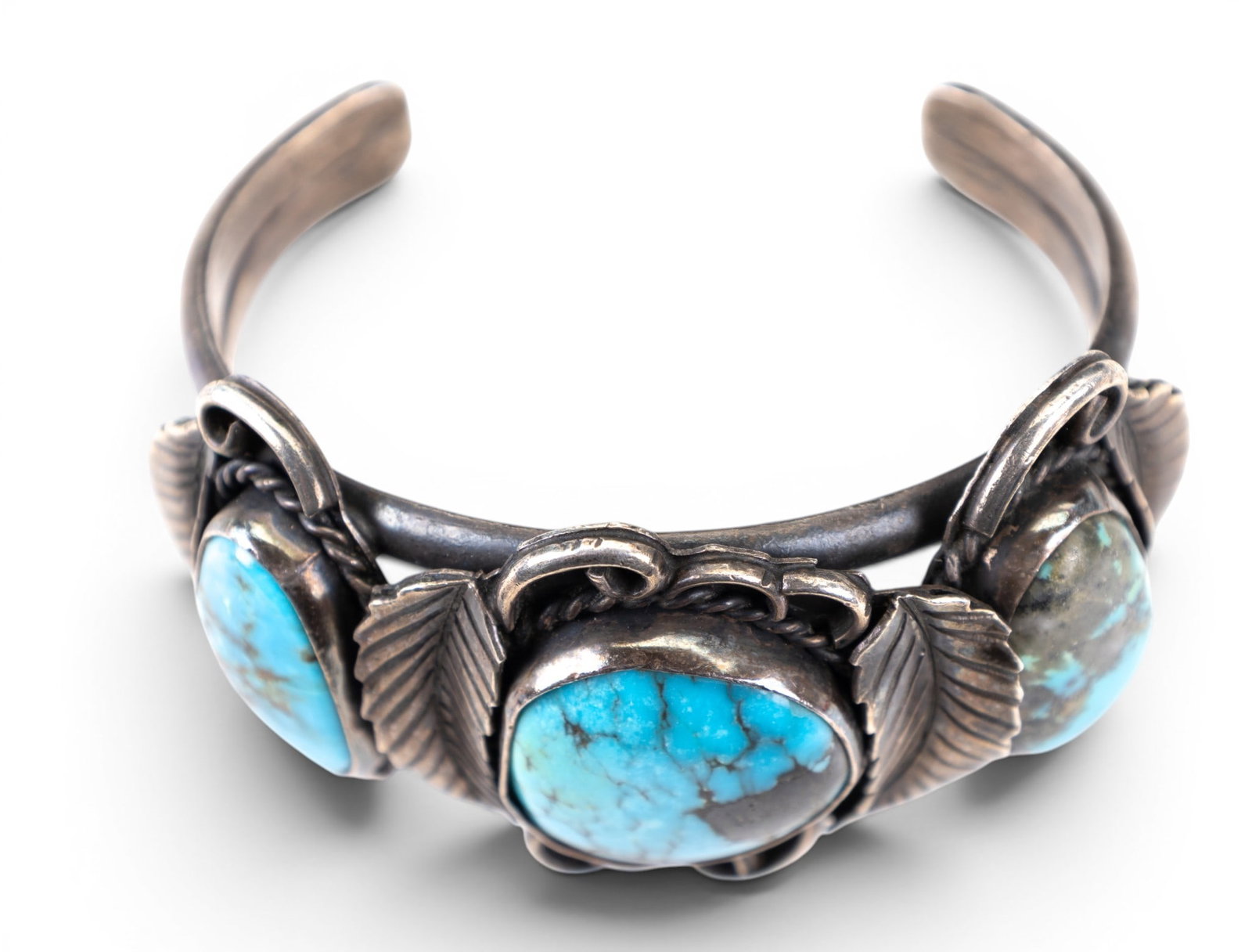 Large Native Cuff Bracelet: Heavy unsigned silver cuff with bright turquoise with natural veining and handmade leaf detail.