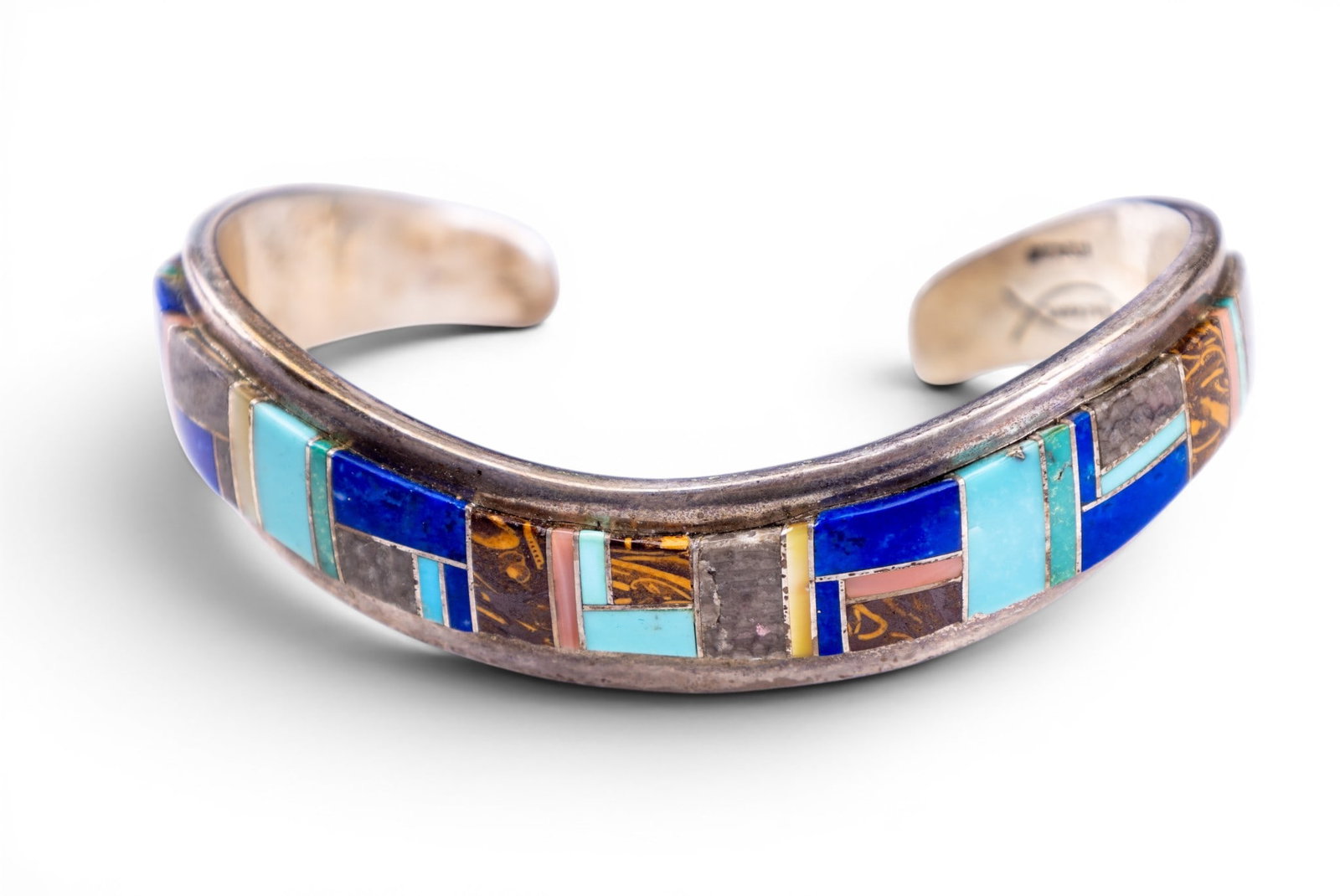 Signed Jackson Native Cuff: Sterling silver vintage Native cuff bracelet signed by maker, "Jackson"; inlaid with lapis, turquoise, tiger eye and agate pieces