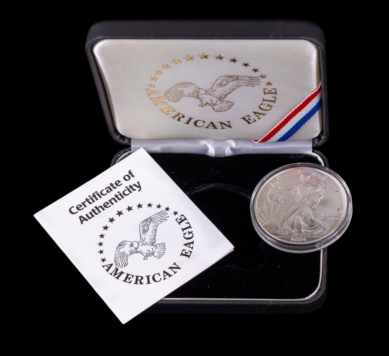 2004 American Silver Eagle Bullion Coin (NIB): A 2004 American Silver eagle bullion coin . Item is still housed in original plastic casing with certificate of authenticity and carrying case.