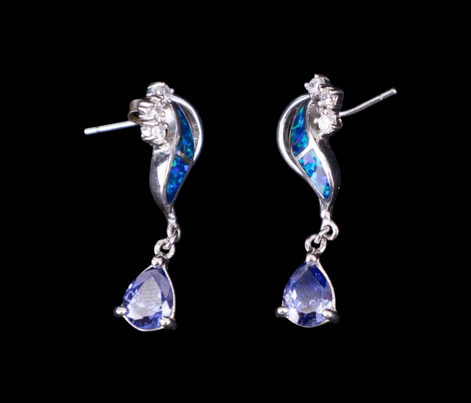 Tanzanite, Opal Pierced Earrings: Sterling silver earrings set with black opal and a dangling trillion cut tanzanite stone