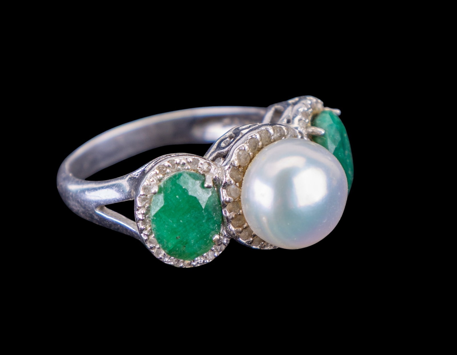 Emerald and Pearl Ring: Sterling silver ring set with white pearl and two emerald stones