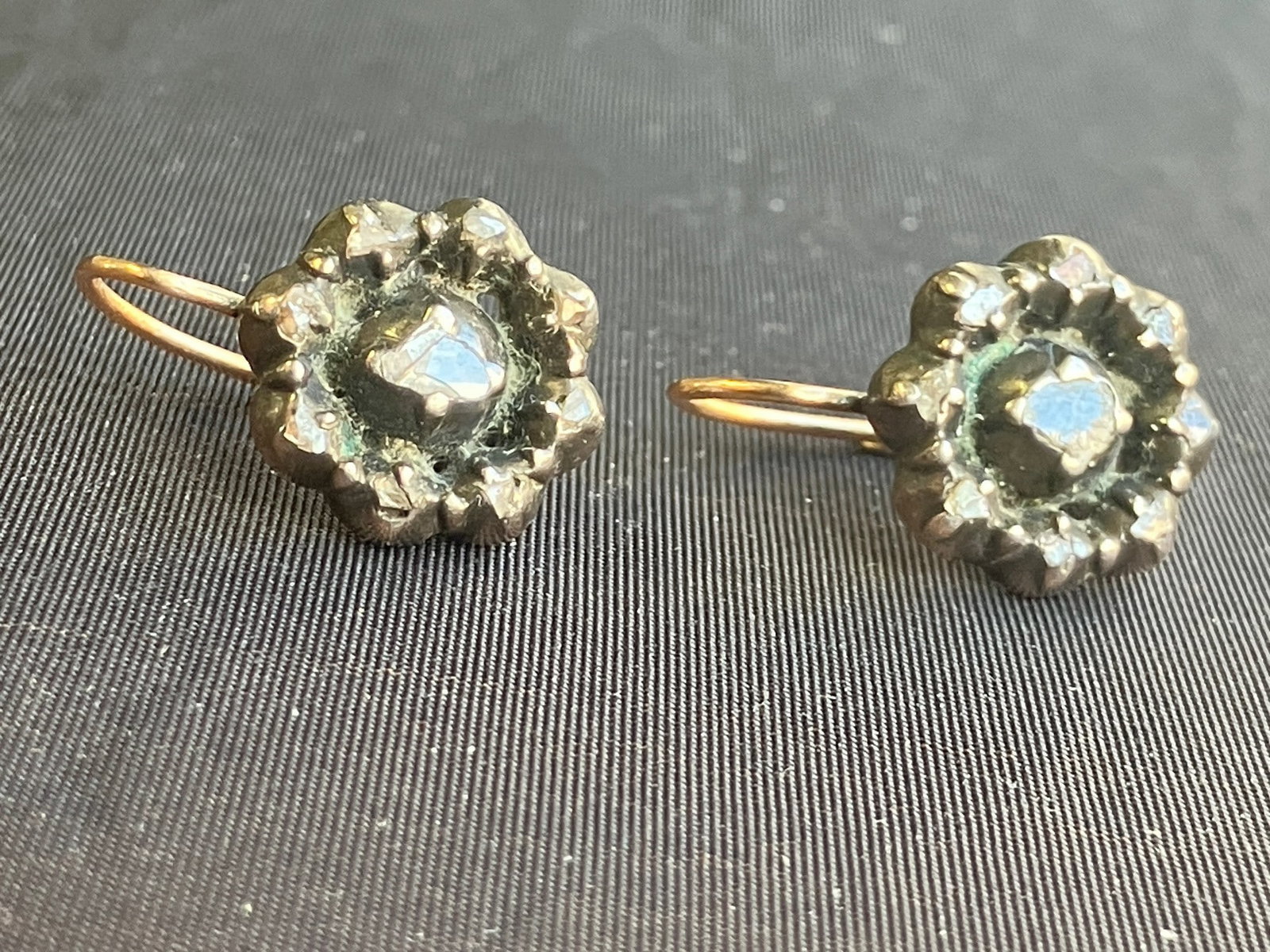 Antique Diamond Earrings: Antique diamonds rough cut in rose shape settings in silver earrings with 14K pierced closure.