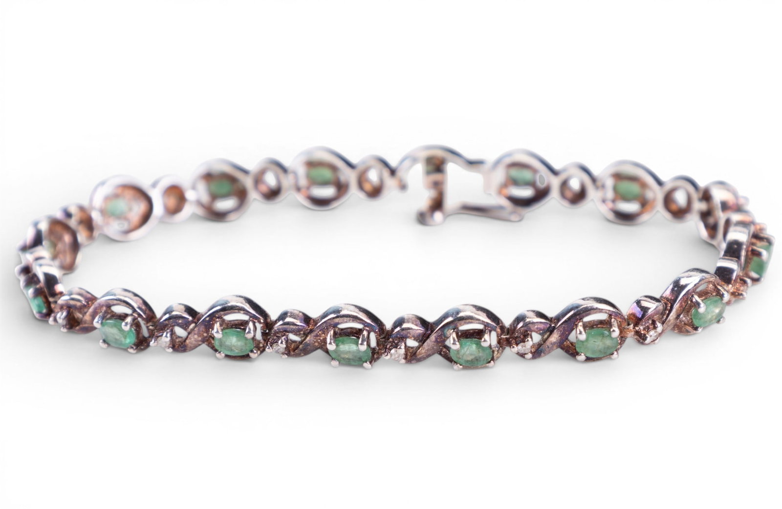 Emerald and Sterling Silver Bracelet: Emerald "tennis style" bracelet set in sterling.