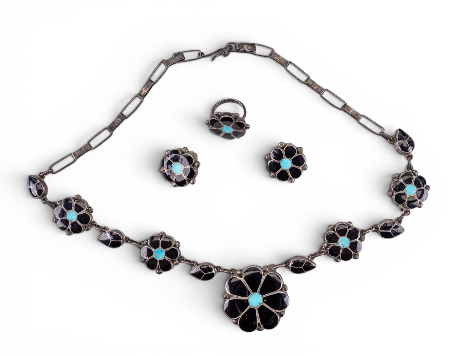 Turquoise Onyx Native American Jewelry Trio: Includes a onyx and turquoise silver panel floral necklace, matching clip earrings and a ring (unsigned).
