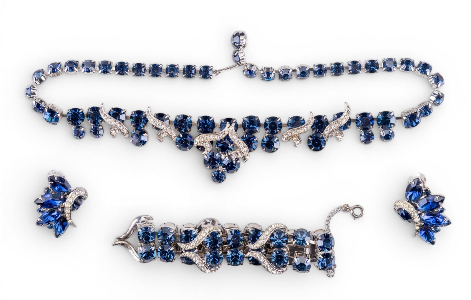 Vintage Blue Rhinestone Jewelry: Includes a matching vintage unsigned rhinestone necklace, wide bracelet and large clip earrings.