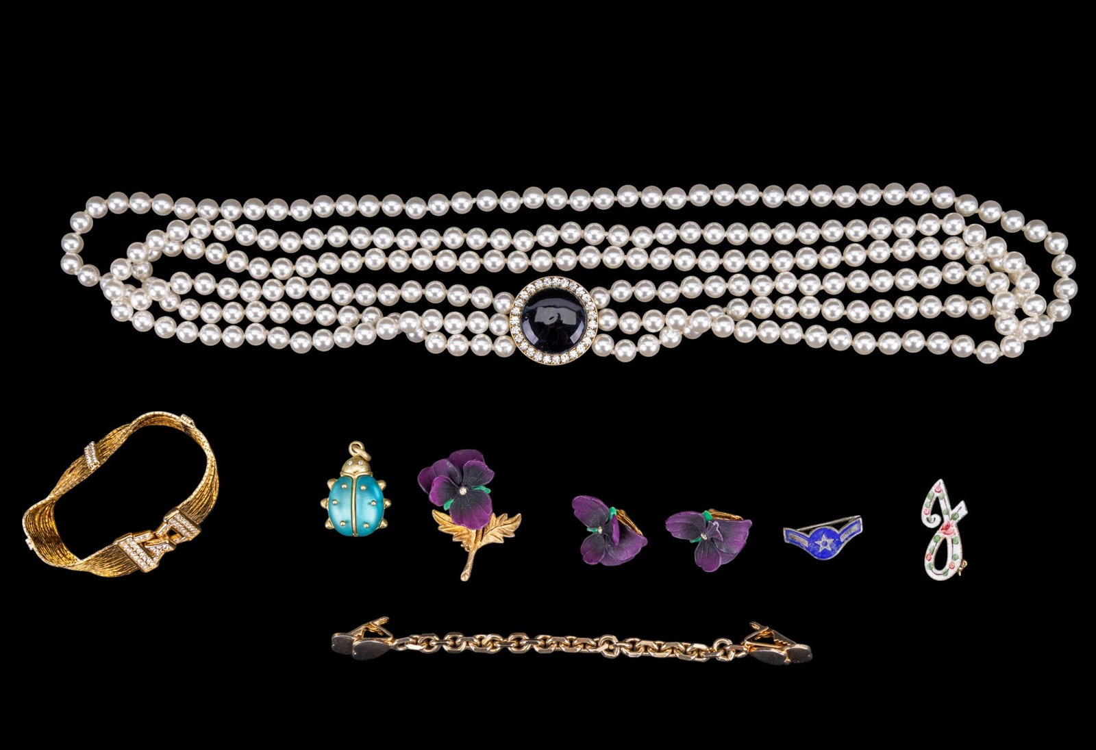 Joan Rivers, Nolan Miller, and Jewelry: Includes a Joan Rivers lady bug pendant, gold tone Nolan Miller bracelet, as well as a "pearl" necklace, fancy jewelry, and more.
