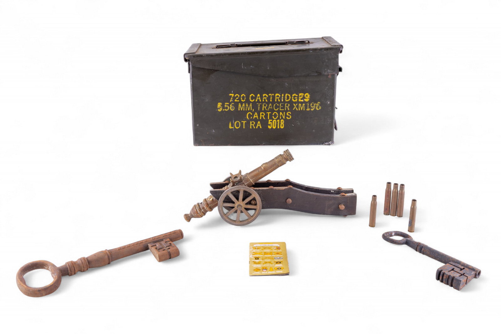Ammo Box, Brass Cannon, Iron Keys: An Army issue ammunition box, five empty high caliber casings, a brass and wood cannon statuette display, and two antique iron skeleton keys.