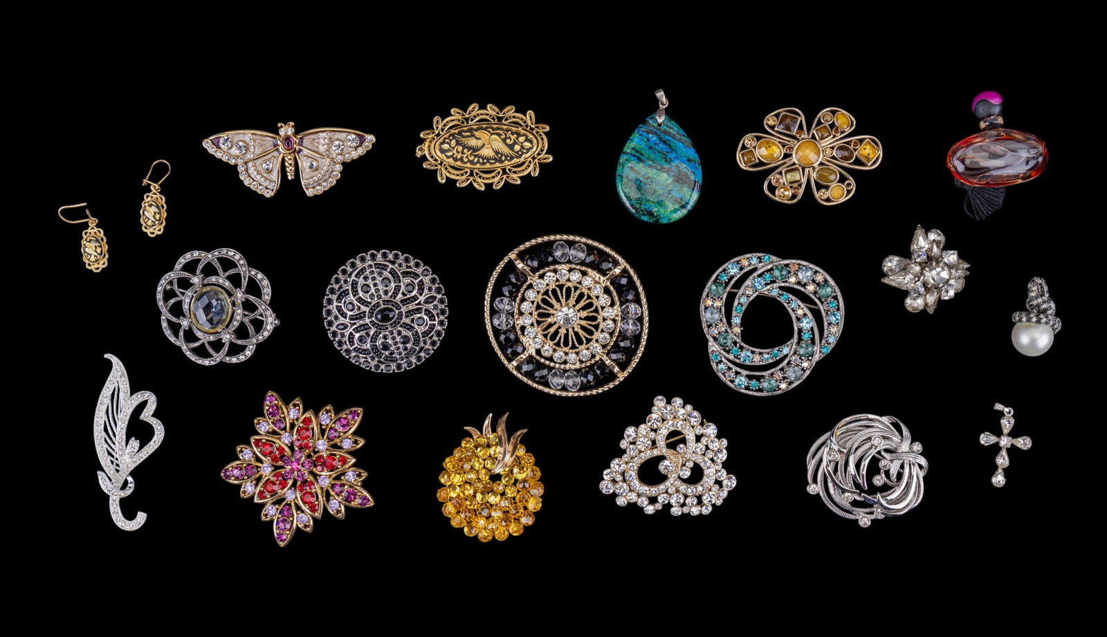 Vintage Rhinestone Brooches: A collection of vintage rhinestone brooches including designer brands such as Trifari, Napier, Monet, and Liz Claiborne. Also included rhinestone Cross pendant, a sample bottle of Avon Far Away perfum