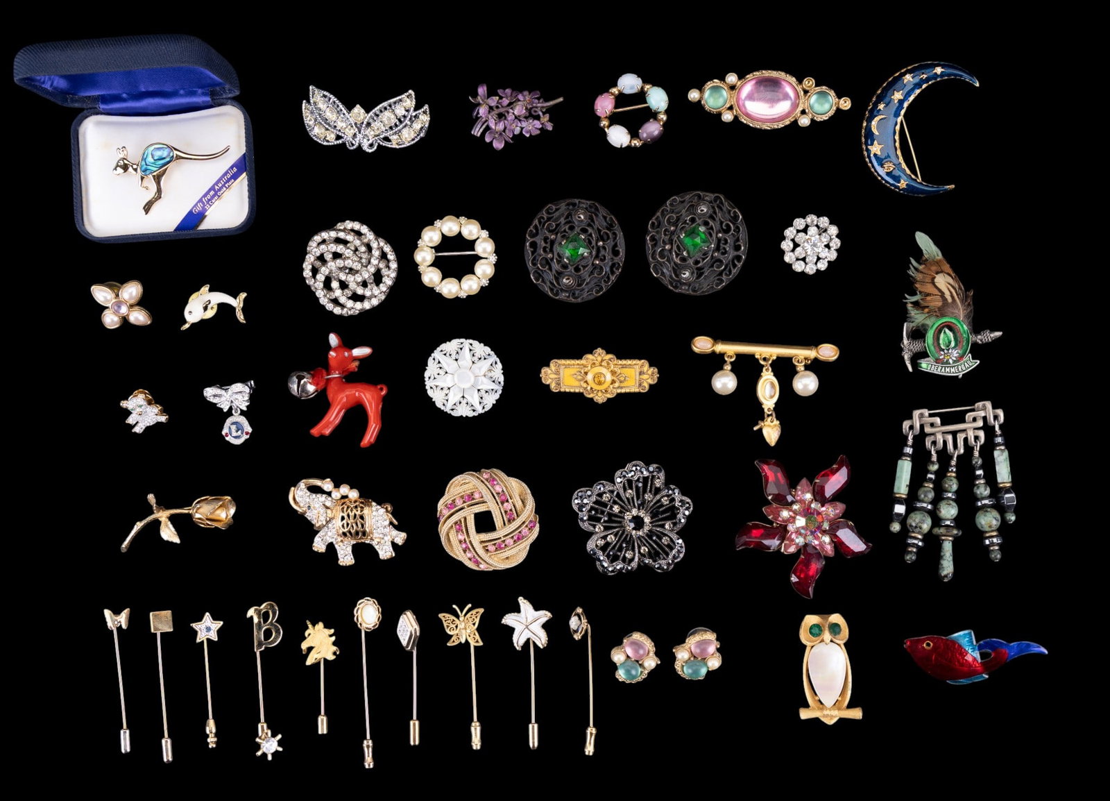 Vintage Rhinestone Brooches and Stick Pins: A collection of vintage brooches including a 22K GP kangaroo brooch with abalone inlay, carved reticluated mother of pearl, a ladies rhinestone Lions Club lapel pin, enamel and rhinestone crescent moo