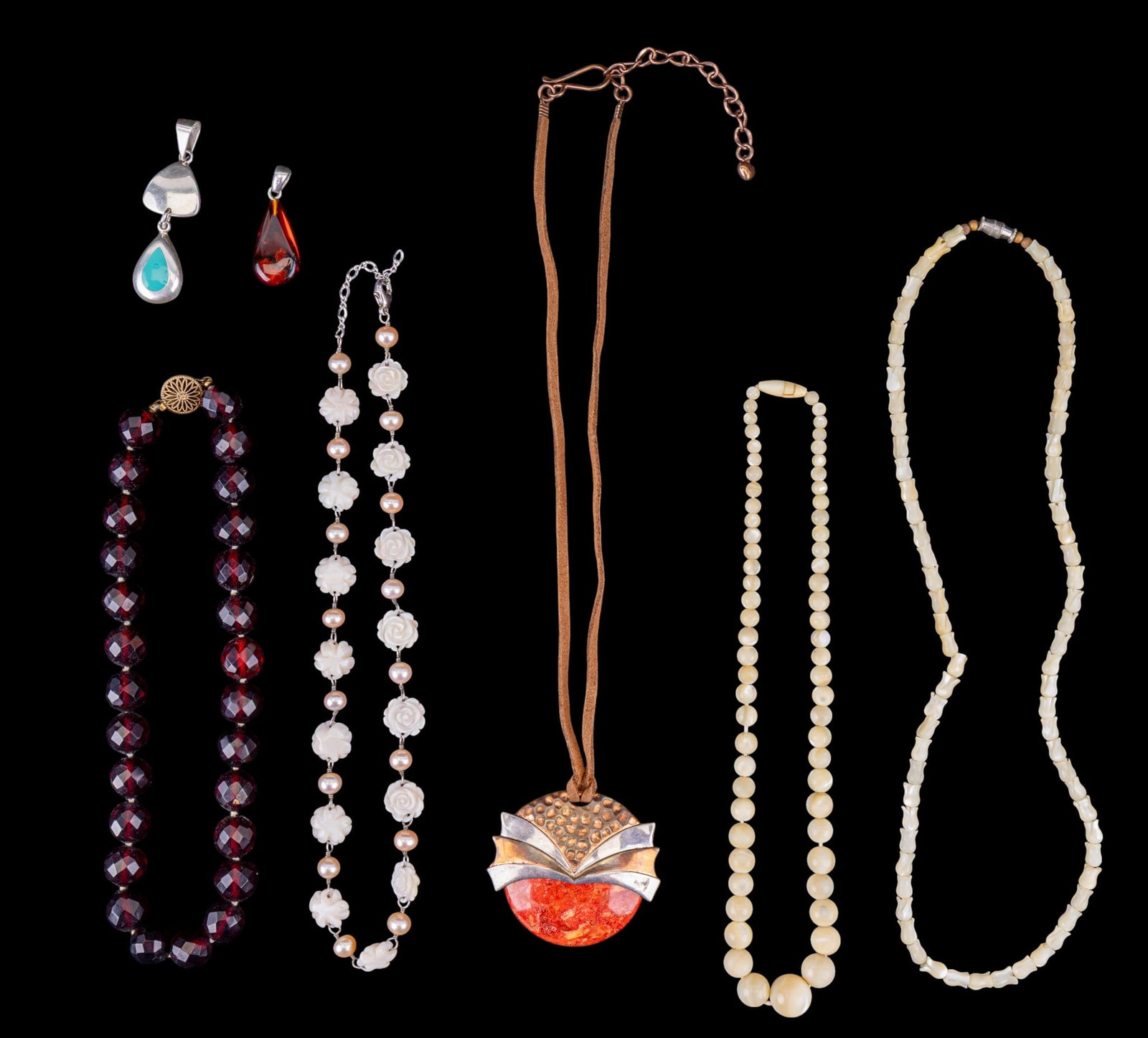 Sterling, Mother of Pearl, and Other Jewelry: A carved mother of pearl rose, cultured pale pink pearl, and sterling silver necklace, a graduated mother of pearl bead necklace, a tulip carved mother of pearl necklace, an artisan pendant with sterl
