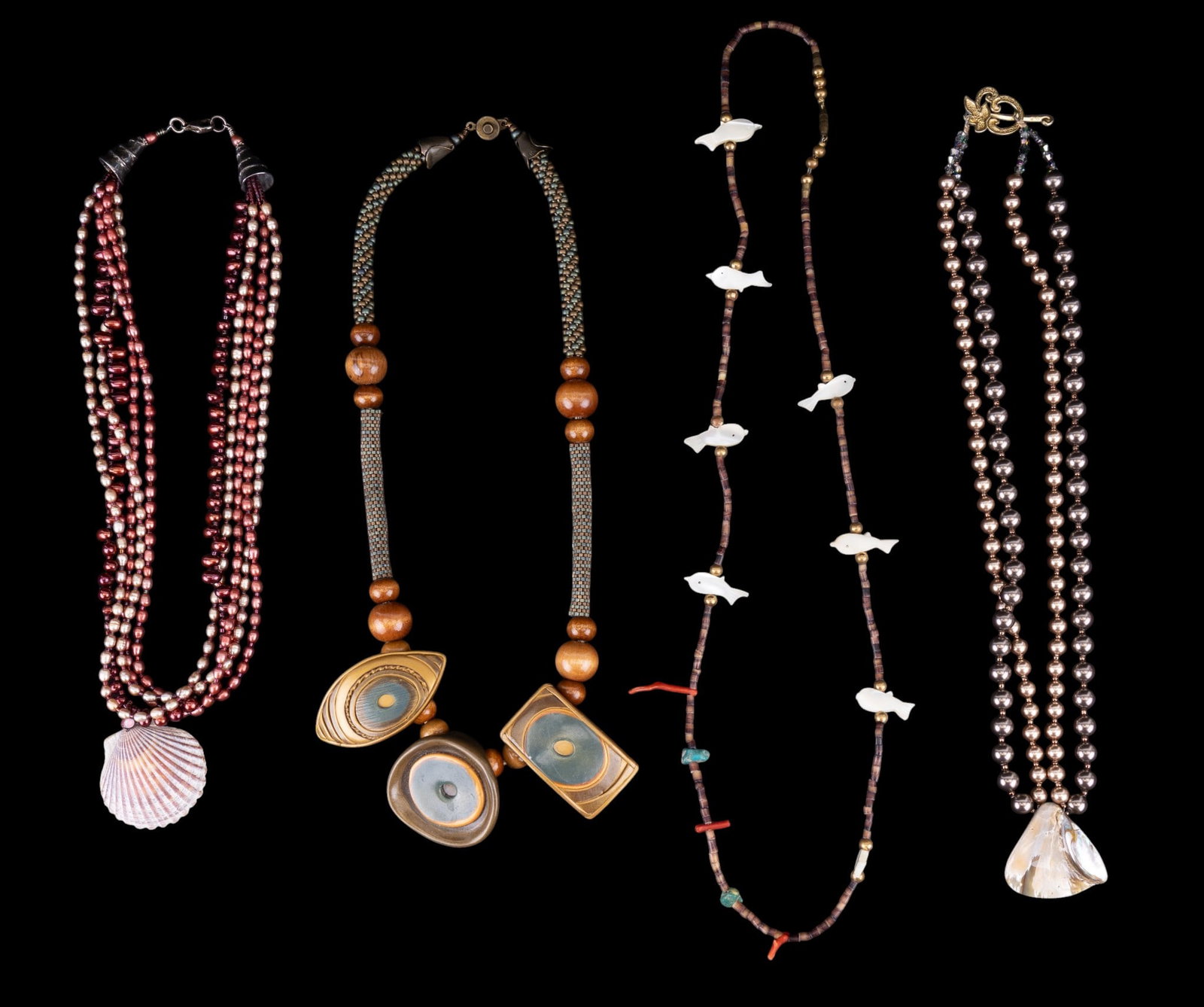 Pearl, Fetish, and Artisan Necklaces: A double strand chocolate and tan pearl necklace with polished shell pendant, a mother of pearl, coral, and turquoise fetish necklace, a hand beaded artisan necklace with polymer pendant and wood bead
