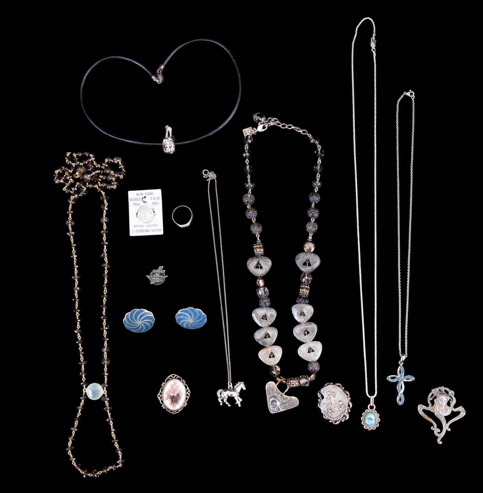 Sterling Silver Jewelry: A collection of sterling silver jewelry including Art Nouveau pendants, Taxco screw back earrings, World's Fair charm, turquoise chip inlay ring, size 6, leather strand and sterling necklace featuring