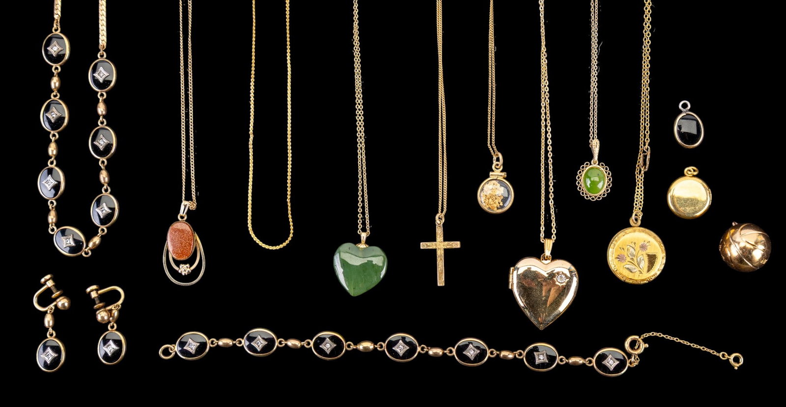 Victorian and Vintage Gold Filled Jewelry: A collection of Victorian and vintage gold filled jewelry including chains with various pendants including etched lockets, jade cabochon and heart shaped pendants, an onyx necklace, bracelet, and scre