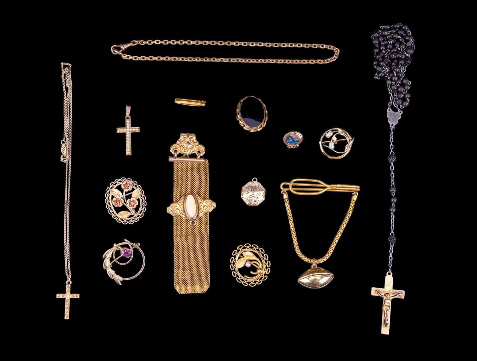 Victorian and Vintage Gold Filled Jewelry: A collection of gold filled jewelry including a Victorian watch fob and chain, an octagonal etched locket, pearl and floral brooches, gold filled cross pendants and Rosary, a vintage football tie bar 