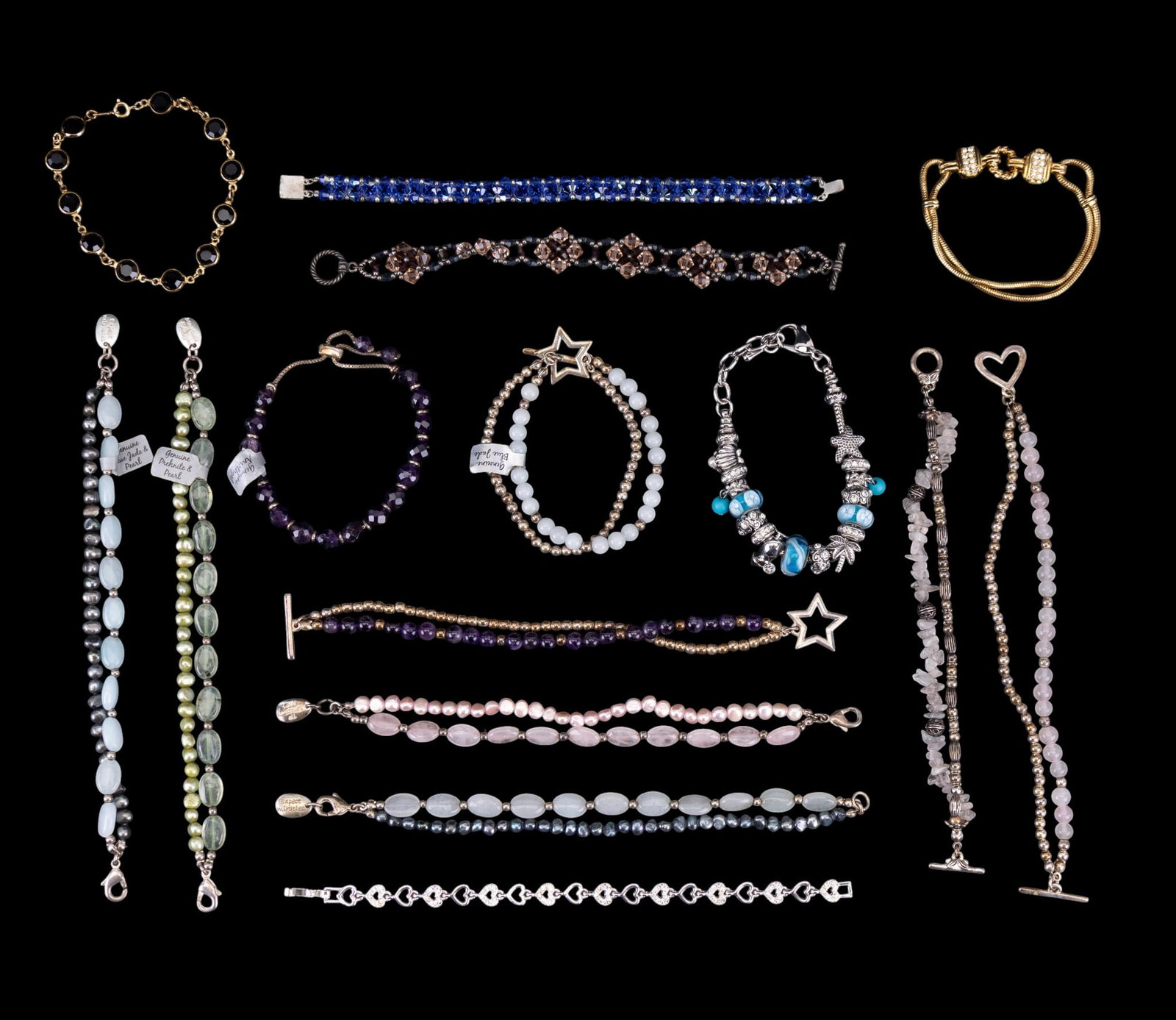 Swarovski, Nolan Miller, & Other Bracelets: A collection of natural stone, rhinestone, crystal, and pearl bracelets including a gold tone and black crystal Swarovski Touchstone bracelet, a gold tone rope and rhinestone bracelet by Nolan Miller,