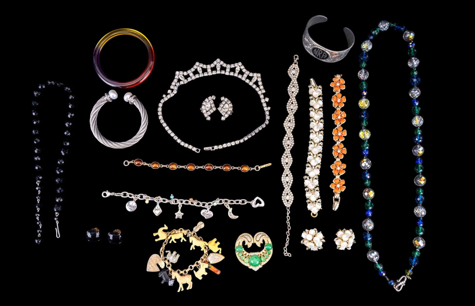 Trifari, Kramer, and Other Vintage Costume Jewelry: A collection of vintage costume jewelry including rhinestone collar necklace and bracelet, a black facet cut crystal necklace made in West Germany, an opera length facet cut blue and green crystal bea