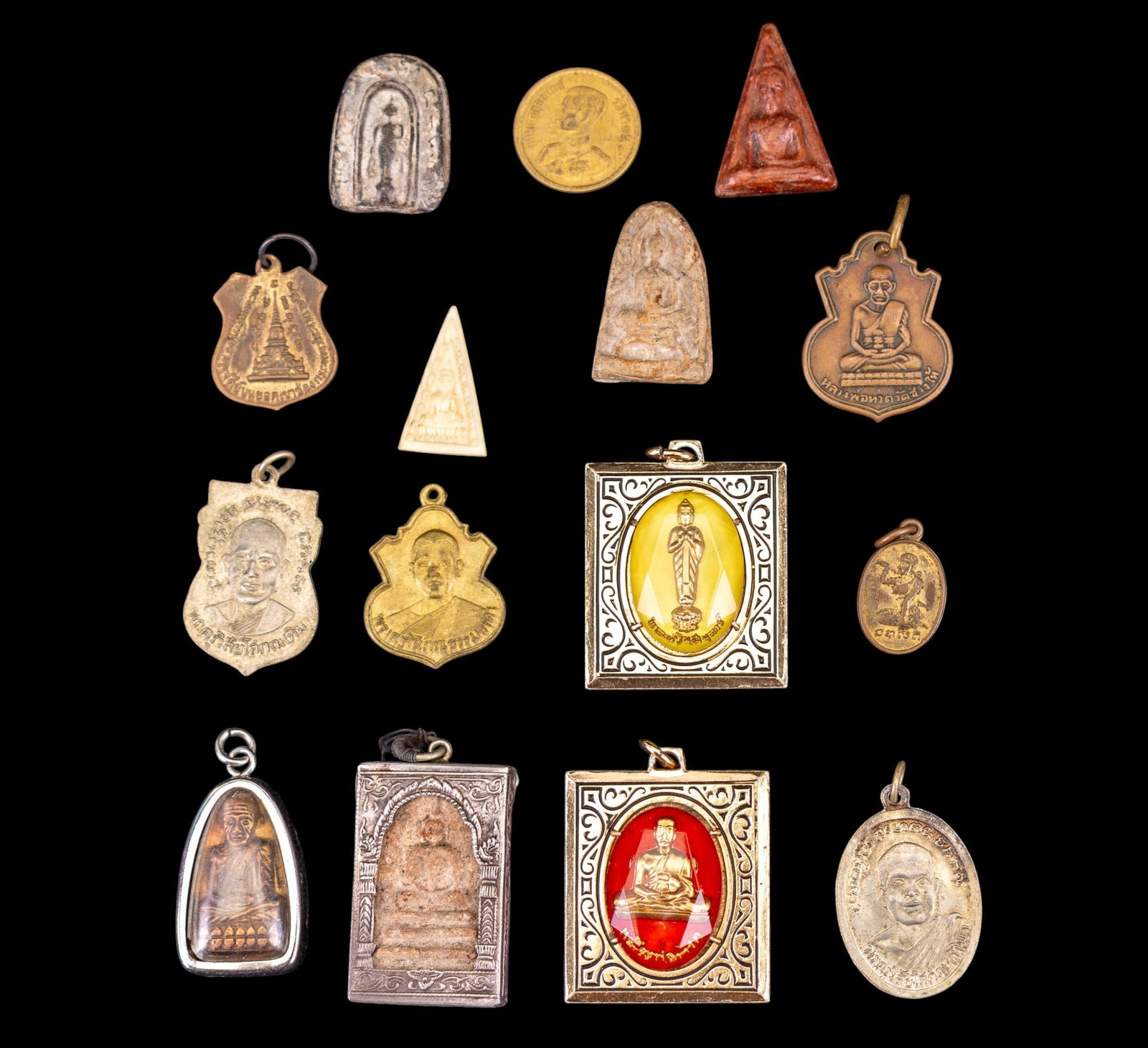Early Indian Amulets and Medallions: A collection of early Indian amulets and pendants including Phra Somdej, Phra Buddha, Prha Gandi, and others.