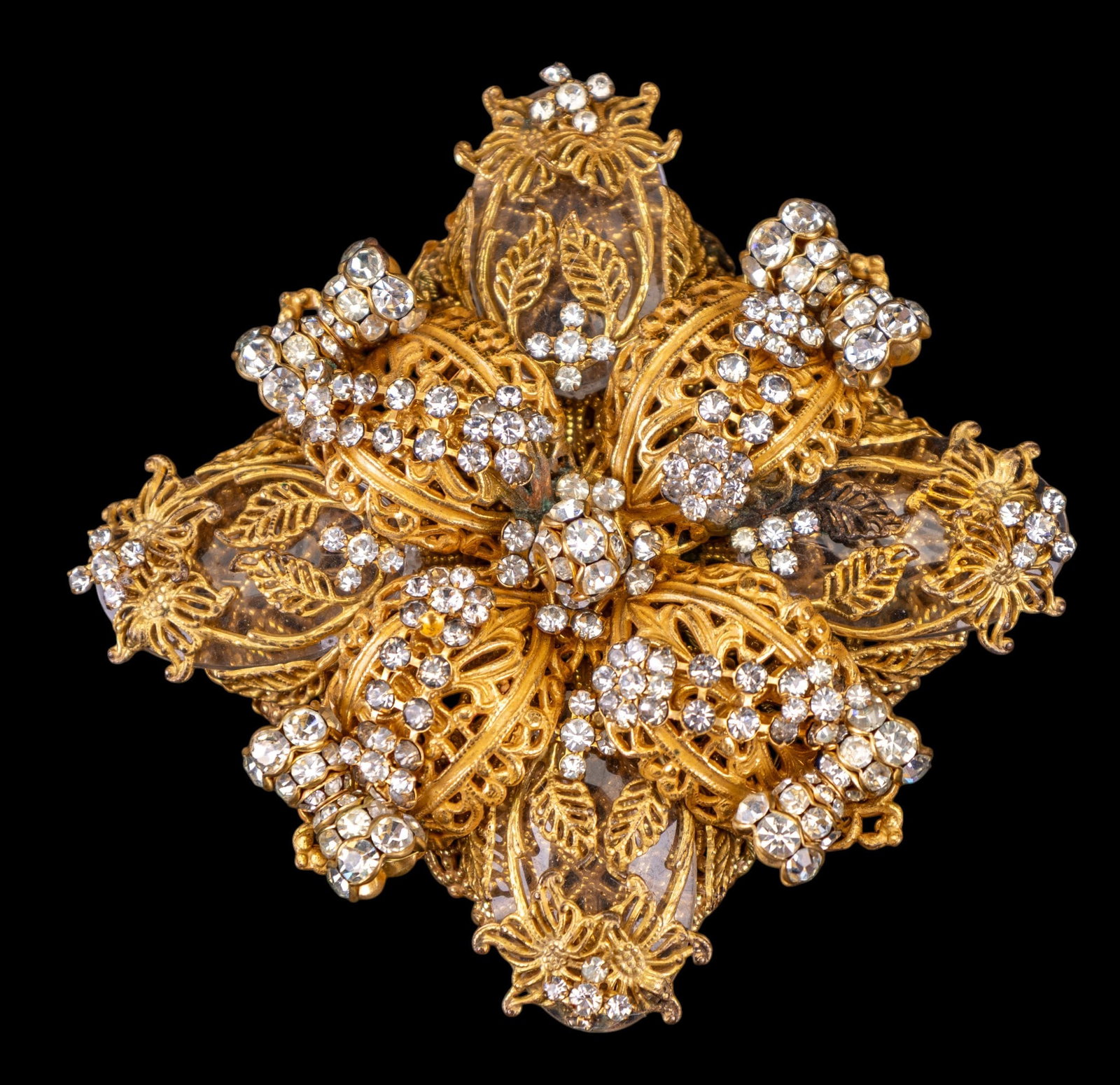 Early Stanley Hagler Oversized Brooch: An early gold tone filigree and facet rhinestone crystal brooch marked on the reverse 'Stanley Hagler NYC', brooch measures approx. 3" W x 3" H.