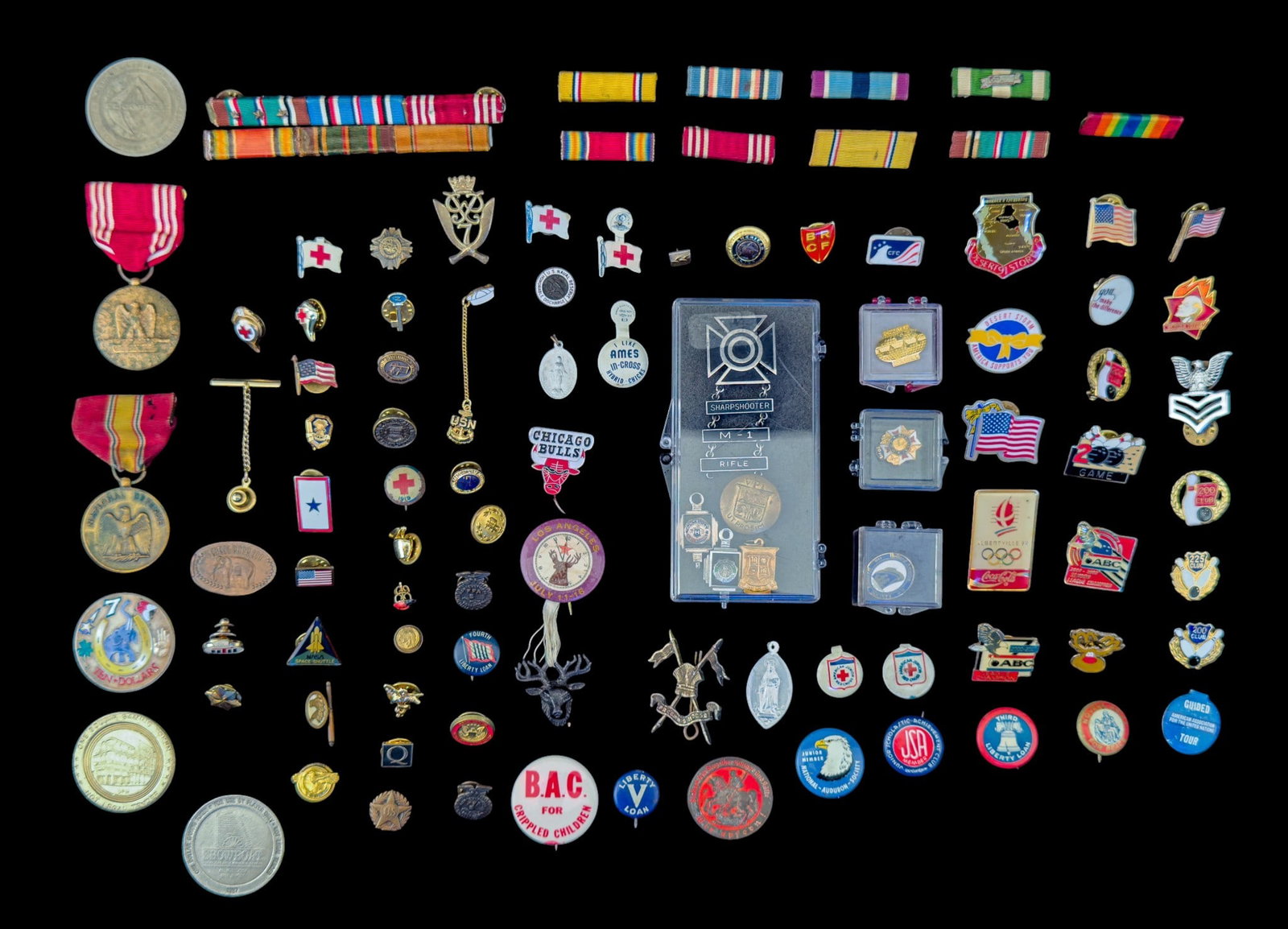 Military Insignia, Lapel Pins, and More: A collection of military insignia including ribbons, pins, and medals, enamel alpel pins, pi9n backs, buttons, and more.
