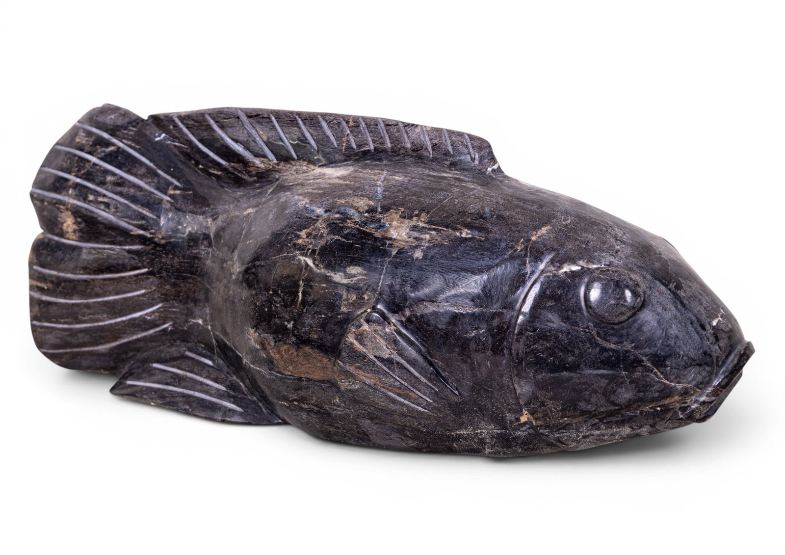Petrified Wood Fish Statuette: A petrified wood fish statuette measuring approx. 6.5" high x 17.5" long x 4.5" deep. Item is in good condition as seen in photography.