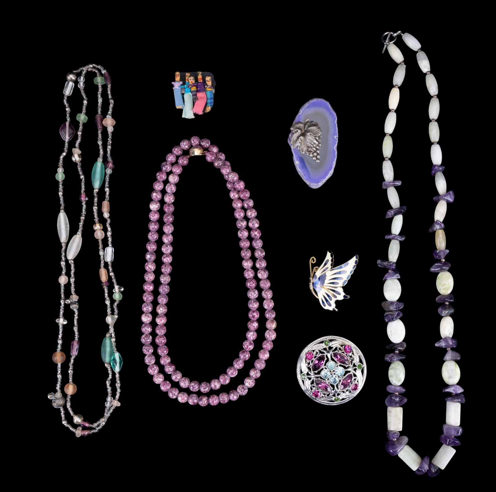 Stone Necklaces and Brooches: A 28" amethyst and milky light green quartz necklace with toggle closure, a vintage 34" thulite bead necklace, a 2 1//8" Sarah Coventry "Springtime" collection (1972) brooch, a dyed geode agate (slice
