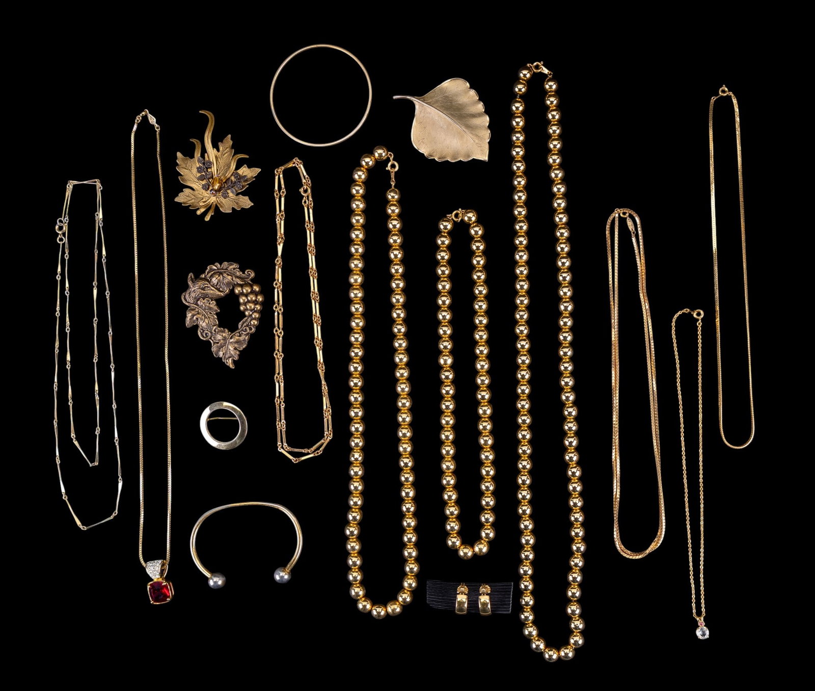 Gold Tone Costume Jewelry: Including 9 necklaces, 2 bracelets, 4 pins, and clip earrings. Group features Monet 1/4" hoop clip earrings and a Monet 1/8" bangle bracelet, a Biagi 24" necklace with a red square glass pendant and c