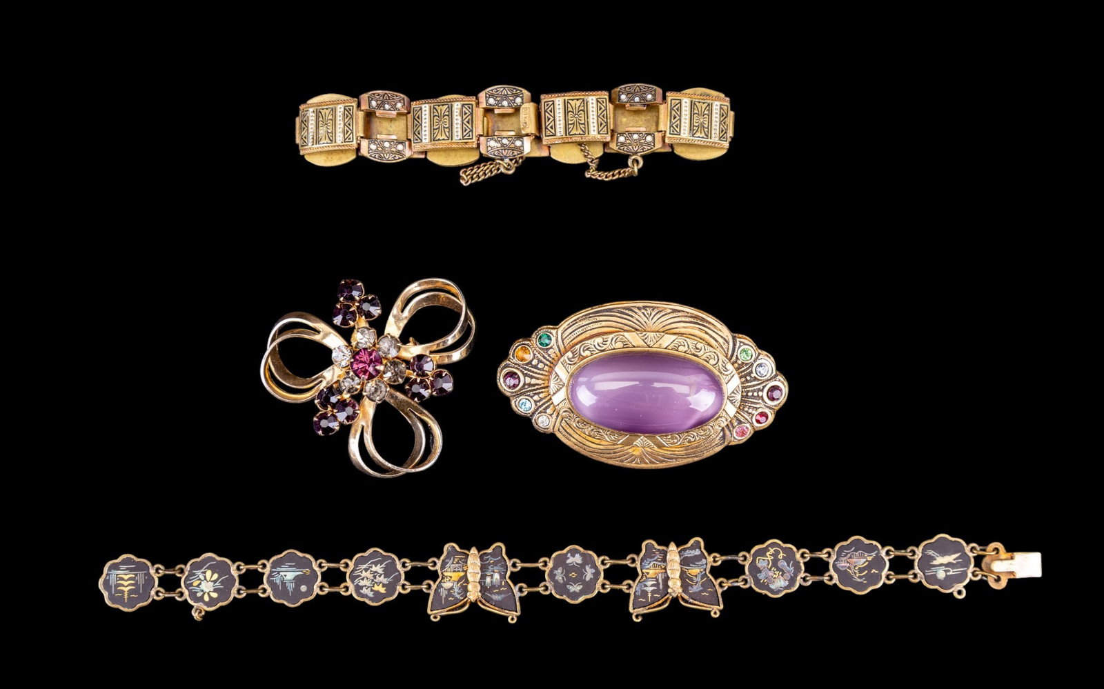 Vintage Pins and Bracelets: This group features a 2 1/2" x 1 1/2" vintage pin with incised Art Deco motifs on the surrounding center oval lavender glass cabochon and outer edge multi-colored rhinestone accents, a vintage gold to