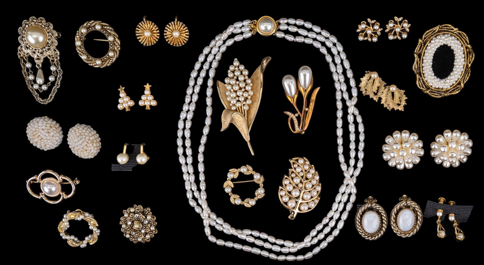 Pearls and Faux Pearls: Many vintage pieces of gold tone and faux pearls and real pearl jewelry, including a 19" 3 strand freshwater pearl necklace with a gold tone clasp, a 3" vintage (1955-69) Crown Trifari brooch, and man