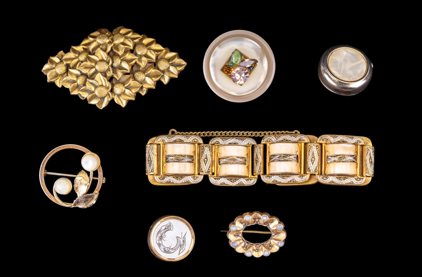 Vintage and Antique Jewelry: Costume jewelry featuring a 7 link damascene bracelet with safety chain stamped Spain on the closure, a vintage Victorian revival 2 3/4" brooch, an antique 1" oval pin with glass opal accents, a Turin