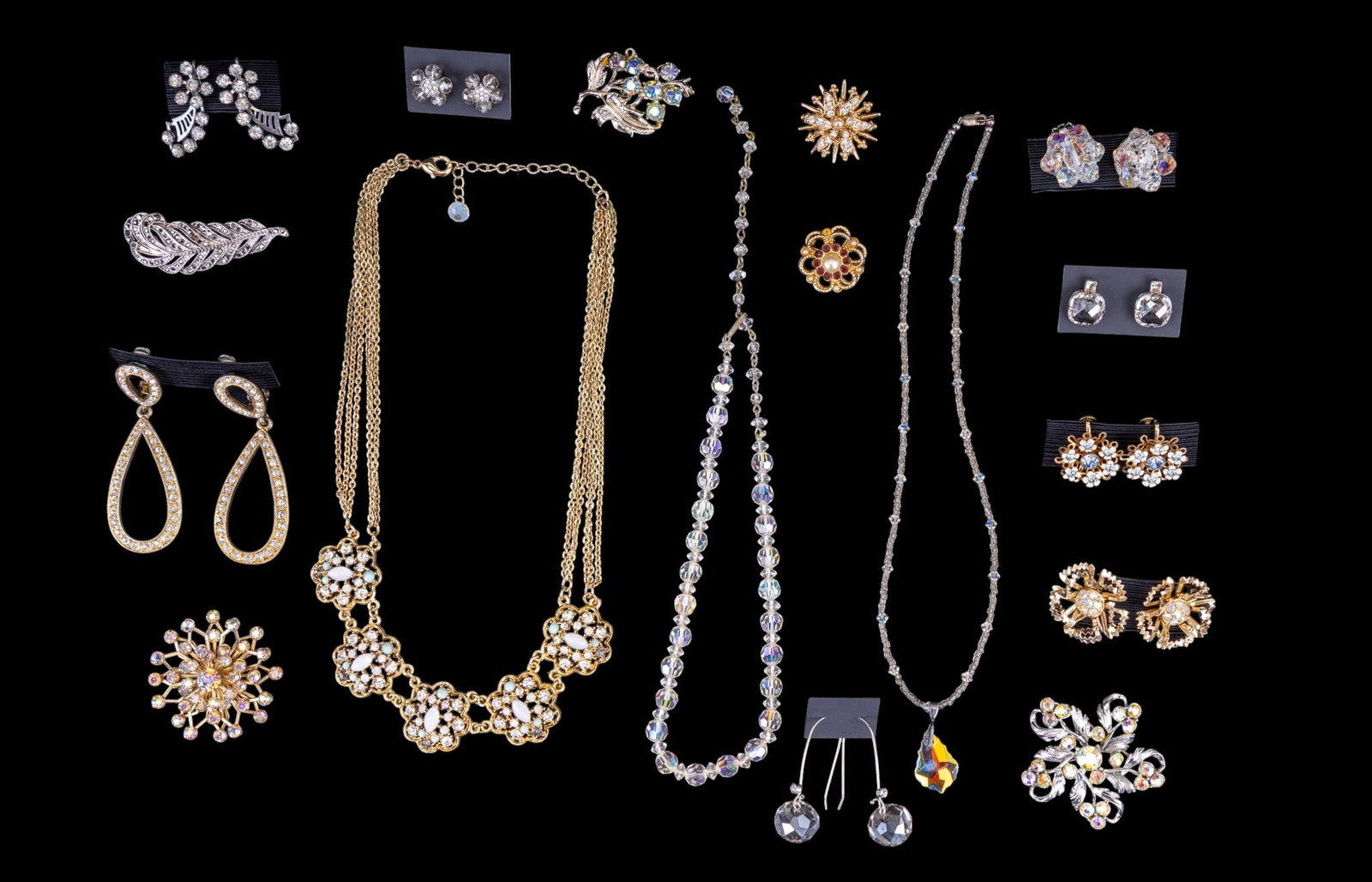 Crystal & Opalescent/Iridescent Jewelry: Seventeen pieces of crystal, opalescent, and iridescent costume jewelry: many pieces are vintage. This group includes a sterling and crystal necklace with a 1" teardrop pendant, a pair of multi-layere