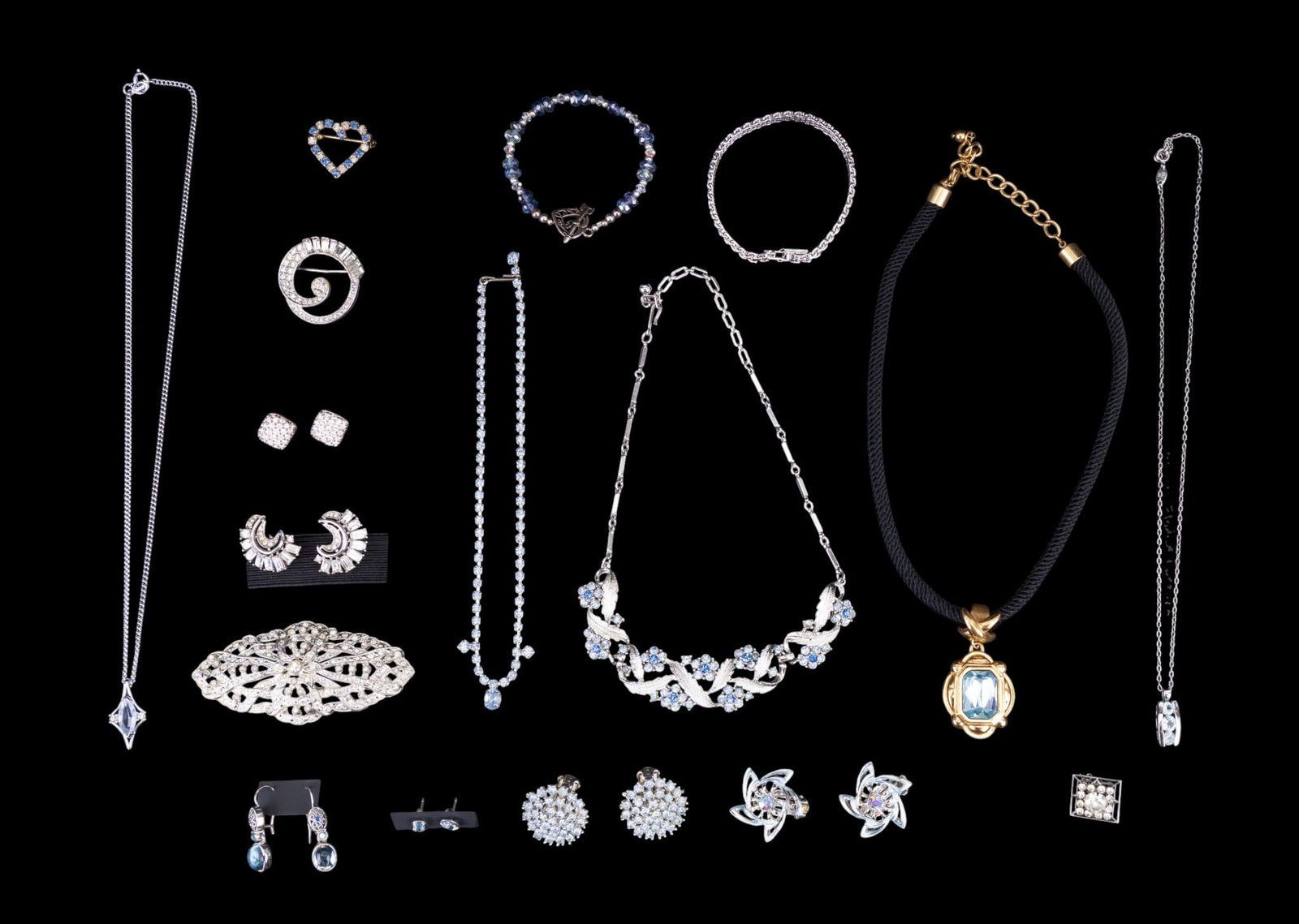 Name Brand and Vintage Jewelry: Beautiful group of jewelry featuring a pair of Crown Trifari (1955 - 69) clip earrings with baguette rhinestones surrounding center crescents, a Coro silver tone bib necklace with blue rhinestone flow