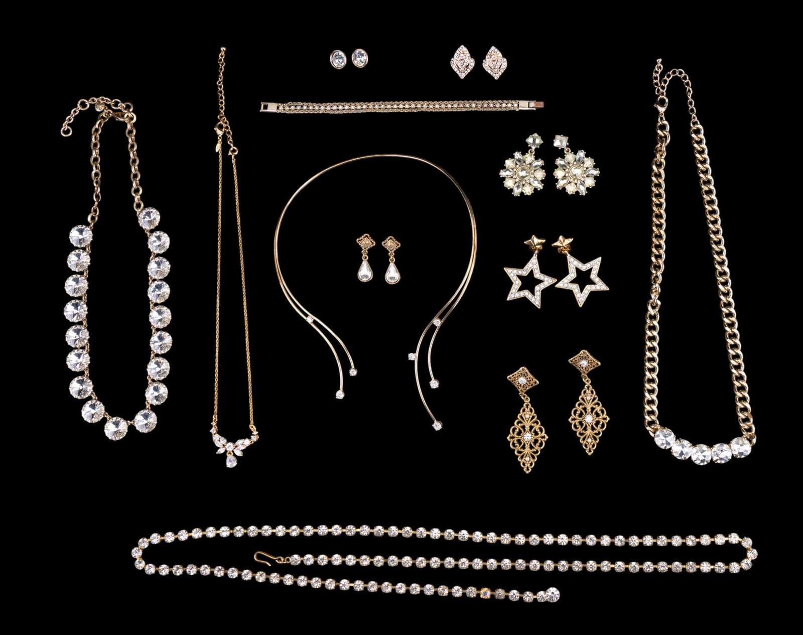 Gold Tone & Bling Jewelry: Gold tone and many prong set rhinestone pieces of jewelry. Group includes one 38" prong set rhinestone belt, a 16 1/2" Avon "Honor Society" necklace with prong set crystals, a 20" J. Crew necklace
