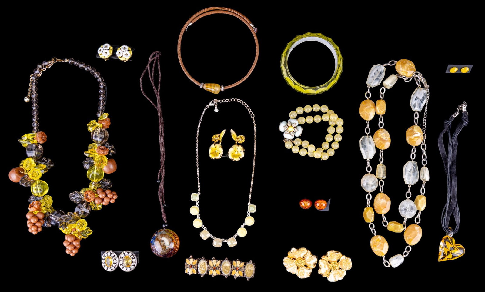 Statement Costume Jewelry: Statement costume jewelry featuring a sweet pair of yellow and white flower vintage Trifari clip earrings, a pair of Austrian clip flower earrings with crystal accents, a domed Lucite shell and stones