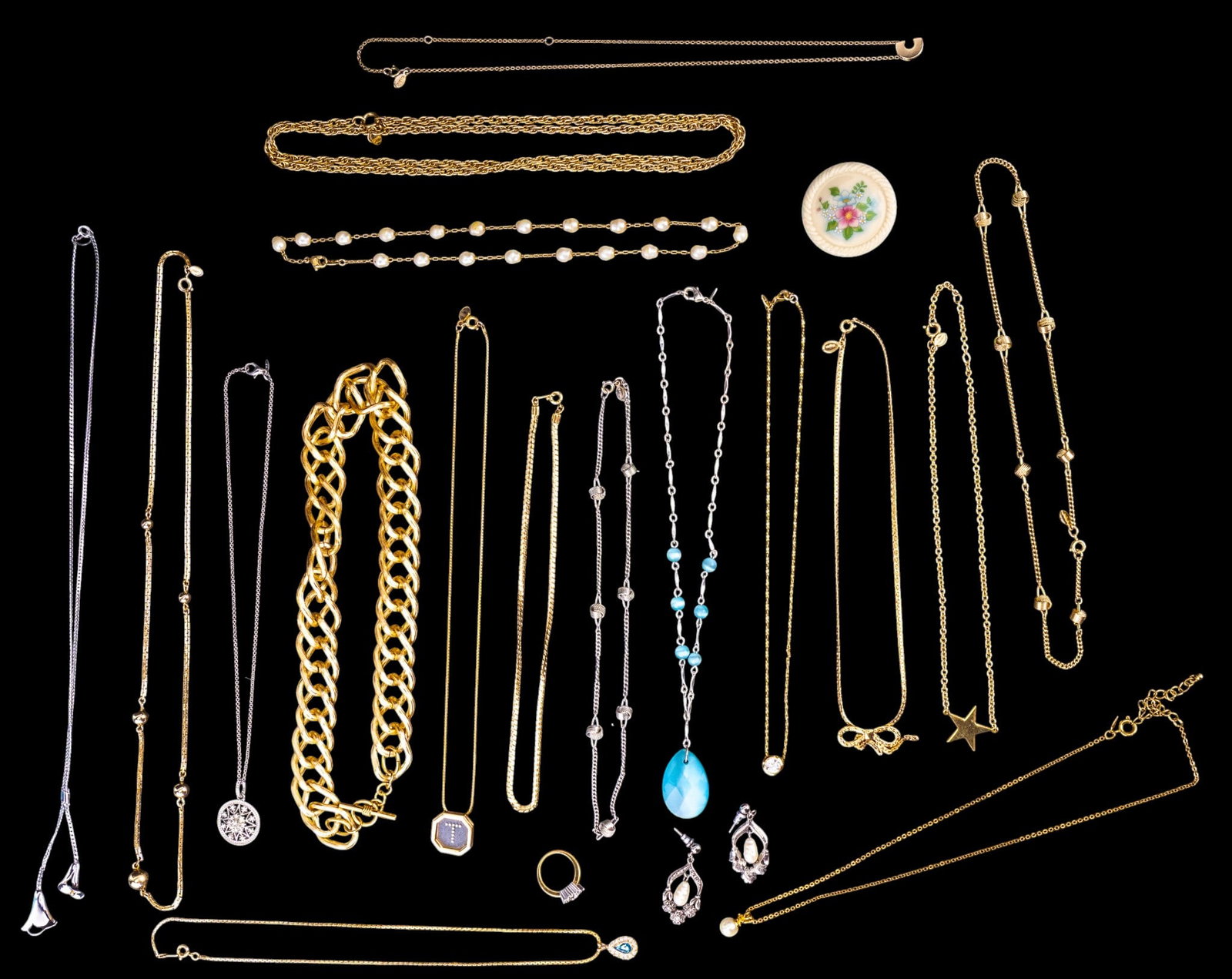 Avon Jewelry Collection: Avon collection of jewelry featuring 17 necklaces, a porcelain flower pin, a rhinestone ring, and a pair of earrings.