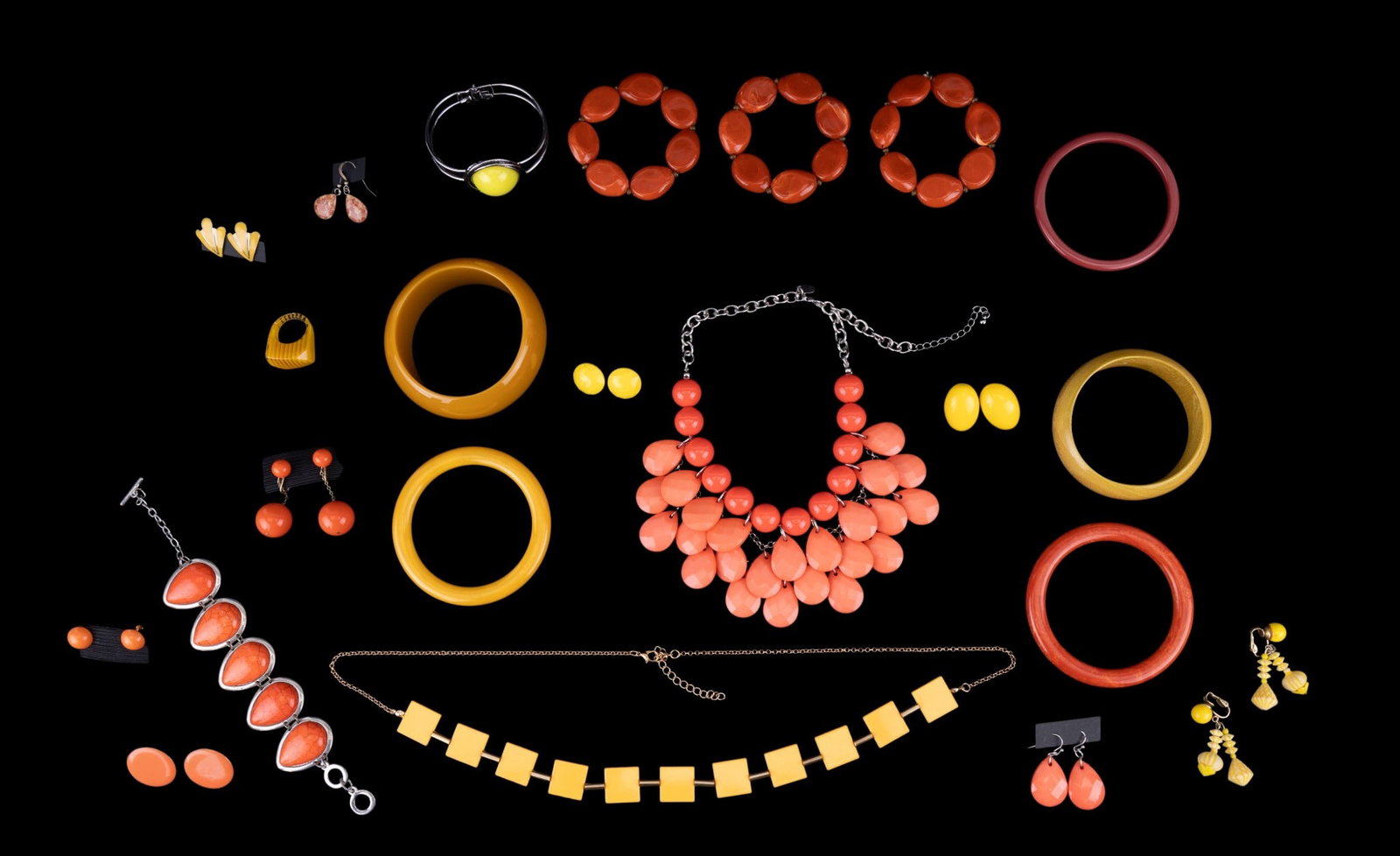Yellow and Orange Costume Jewelry: What fun! Retro to statement jewelry. Twenty-two pieces featuring bangles, bracelets, earrings (clip and pierced), necklaces, and one ring. One pair of sterling teardrop shaped earrings.