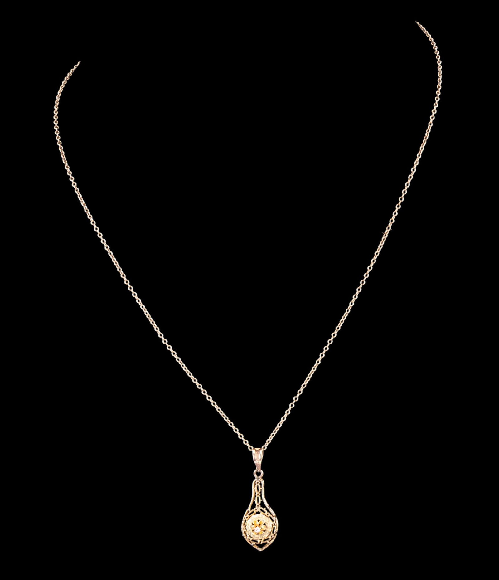 10K Gold Diamond Necklace: A delicate and beautiful Victorian style filigree 1" pendant with a pronged center diamond. Pendant hangs on a 16" 10K chain. (2 gms)
