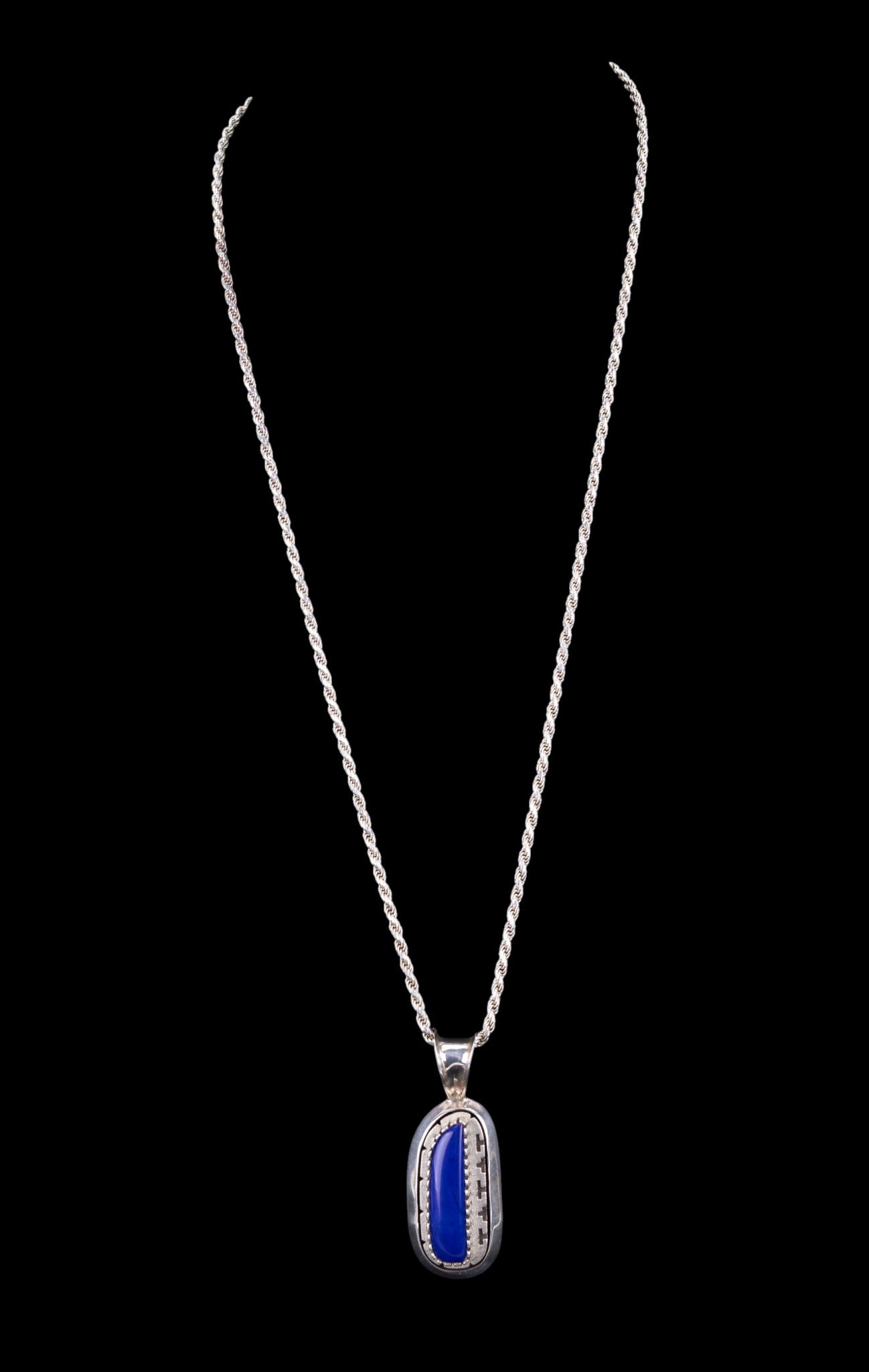 Sterling and Lapis Lazuli Necklace: Beautiful Native American, Navajo, sterling silver and lapis pendant necklace with a cursive "LY" inscribed on back of pendant. The 30" heavy spiral chain necklace is stamped 925 Italy. (59.25 gms TW 