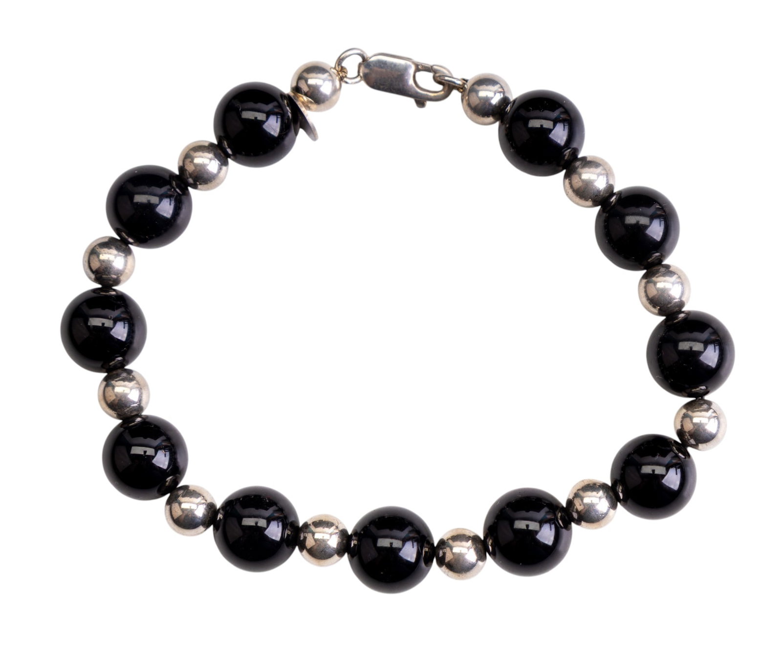 Tiffany & Co. Onyx and Sterling Bracelet: Tiffany & Co. black onyx 10mm beads with alternating sterling silver spacer beads bracelet. This bracelet measures 8". (17.9 gms)