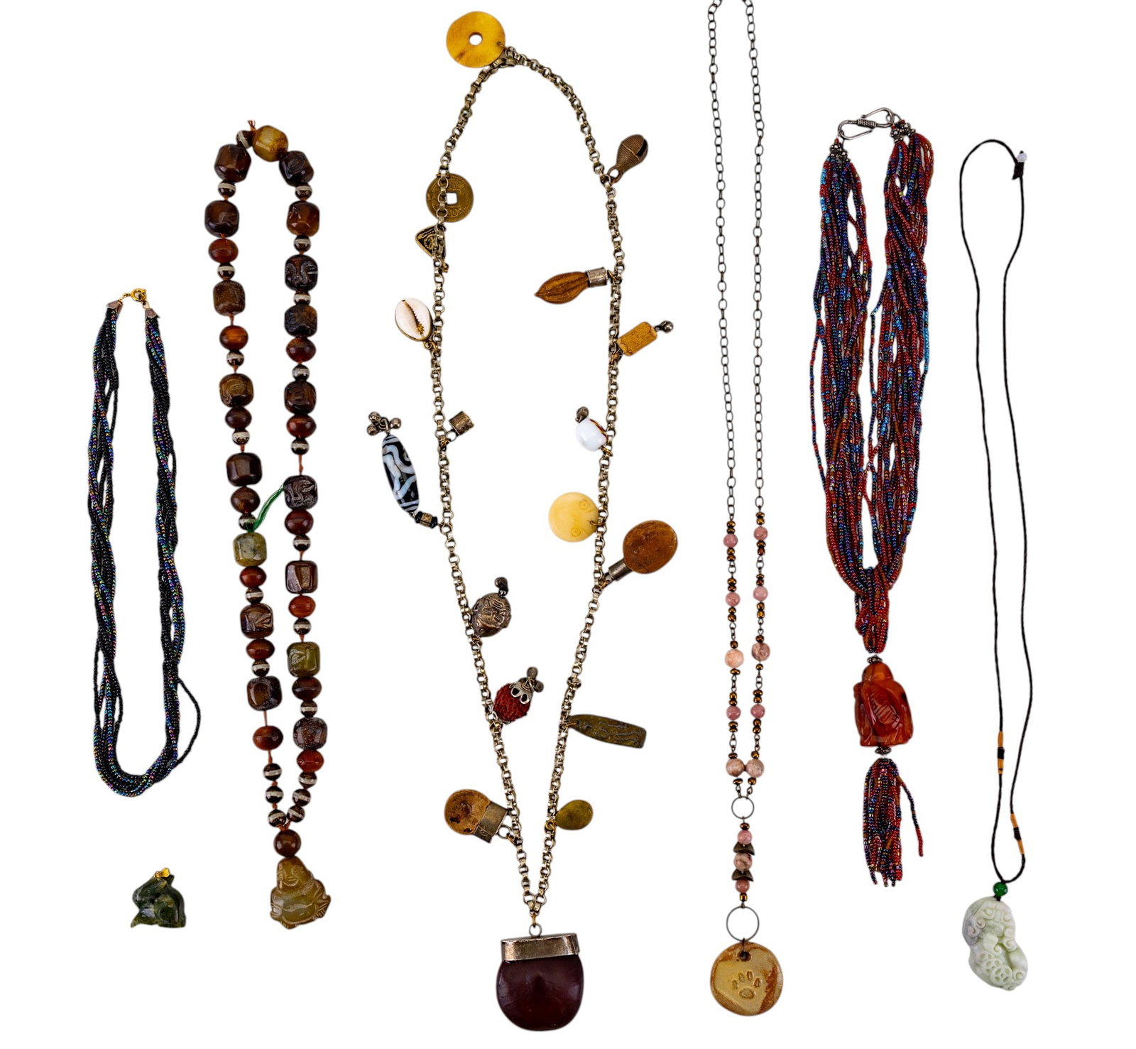 Jade Pendant and Beaded Jewelry / Necklaces: A collection of jewelry including an abraded jade bunny charm, microbead necklaces, a shaman charm necklace, carved stone bead necklace, and more. Longest measures approx. 16" on the drop.