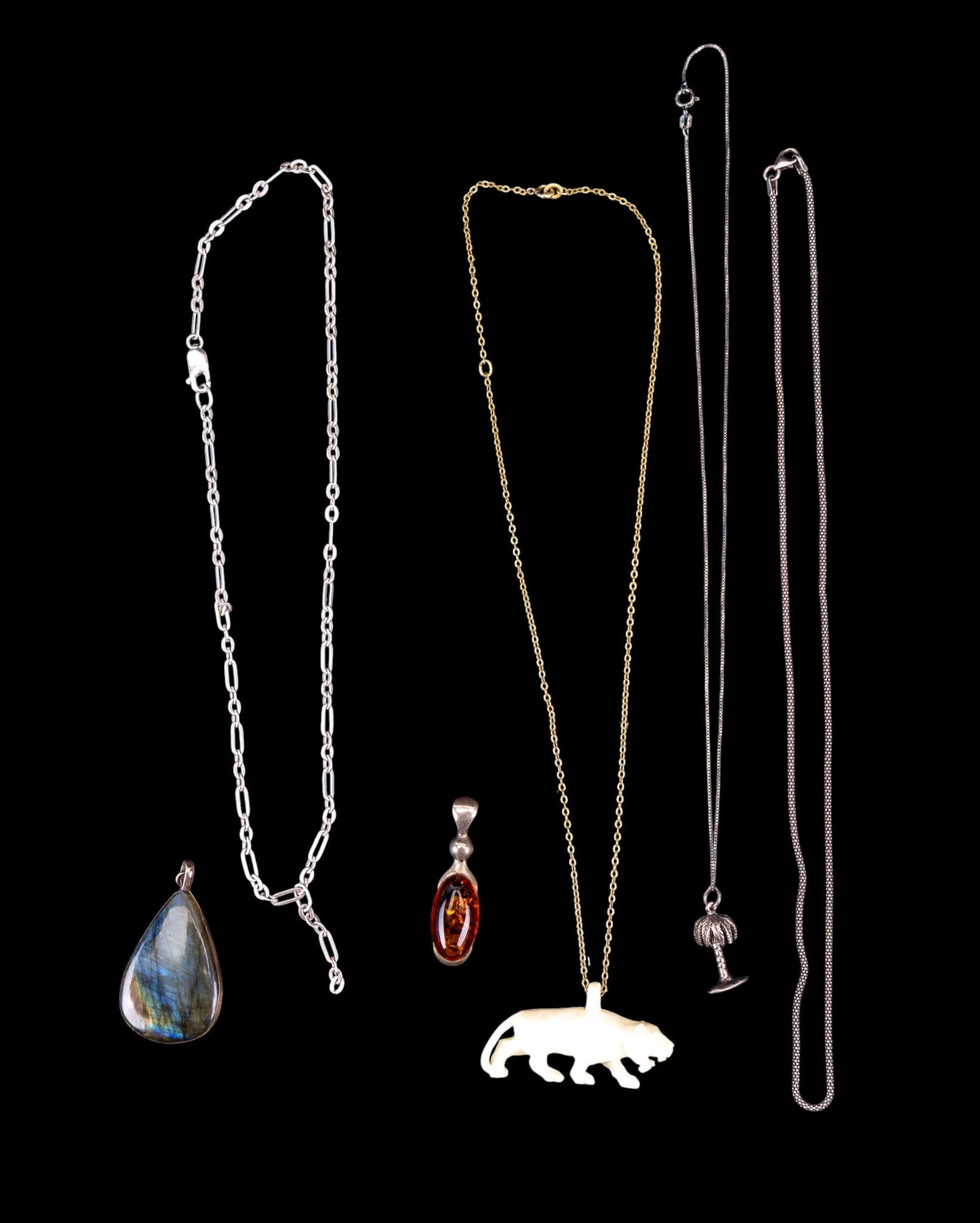 Labradorite, Amber, & Other Sterling Jewelry: A teardrop labradorite pendant in a sterling setting, an oval cabochon and sterling pendant, a sterling paperclip chain, a sterling rope chain, a 12K over sterling chain with carved natural material t