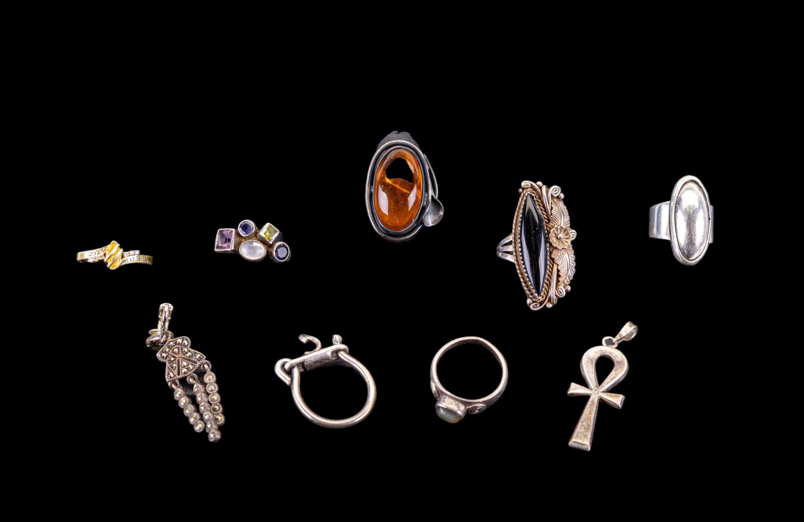 Sterling Silver Rings, Pendants, and More: A collection of seven sterling silver rings featuring an Art Nouveau oval amber cabochon ring, an onyx ring signed 'D. Ashley', and others, sizes range from 4 to 8.5, Also included is a sterling silve