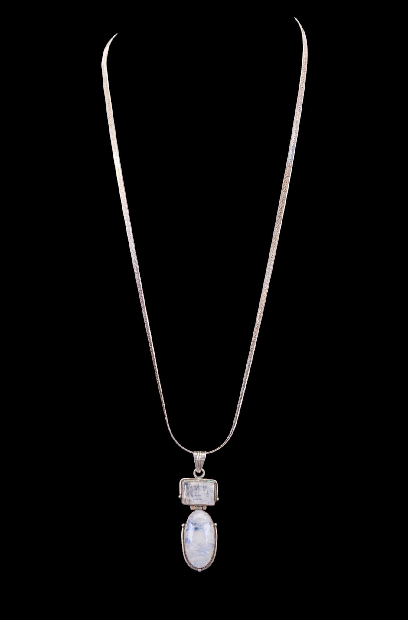 Moonstone Pendant Sterling Herringbone Chain: A sterling silver pendant featuring oval and rectangle moonstone cabochon on an Italian sterling 14" Herringbone chain marked 925.