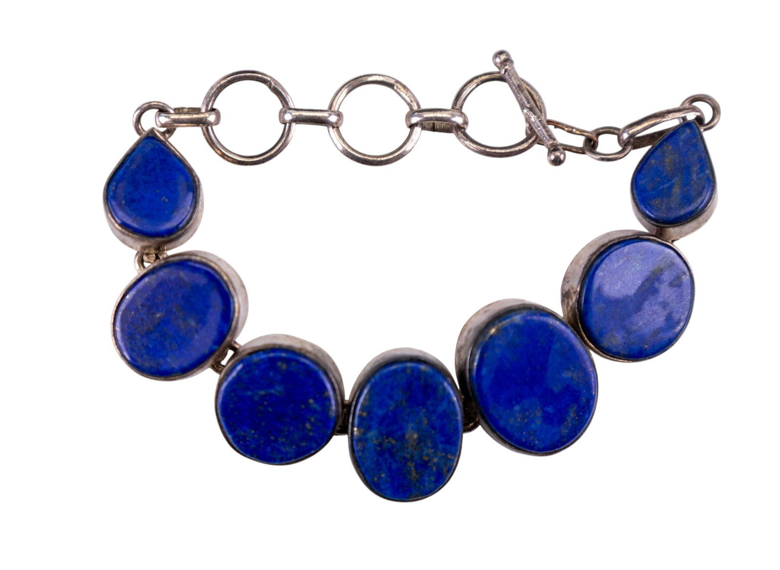 Sterling Silver Lapis Lazuli Toggle Bracelet: A fine sterling silver toggle bracelet featuring round, oval, and teardrop lapis lazuli.