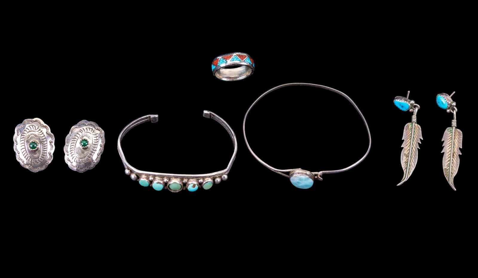 Vintage Sterling Jewelry, Some N.A. Turquoise: A collection of vintage Native sterling jewelry including a larmiar cabochon hooked bangle, feather drop stud earrings with turquoise cabochons, concho style stud earrings with malachite centers, a tu