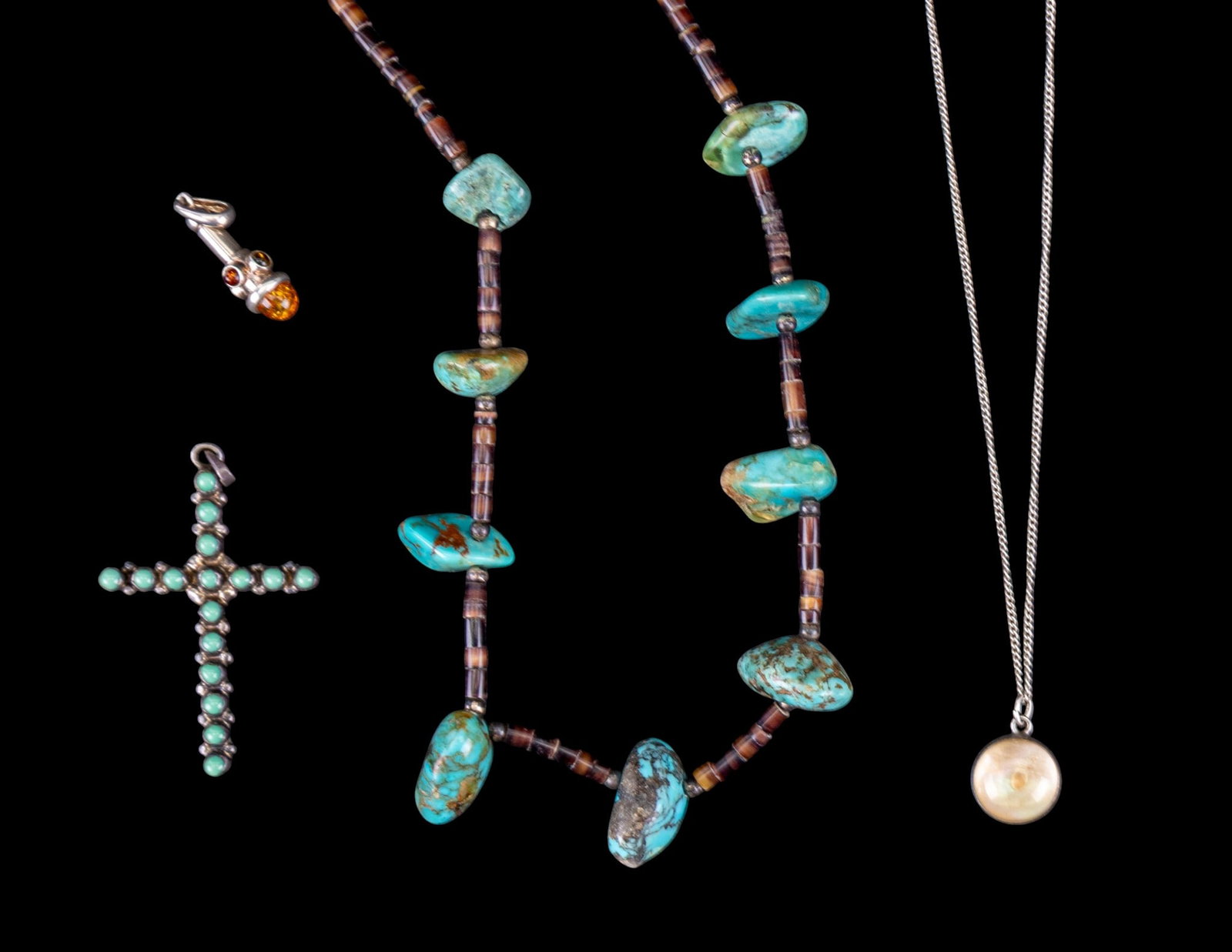 Turquoise and Amber Sterling Jewelry: A turquoise cabochon sterling Cross pendant, a sterling chain with mother of pearl mustard seed pendant, measures approx. 9" on the drop, a sterling and amber pendant, and a turquoise nugget and heish