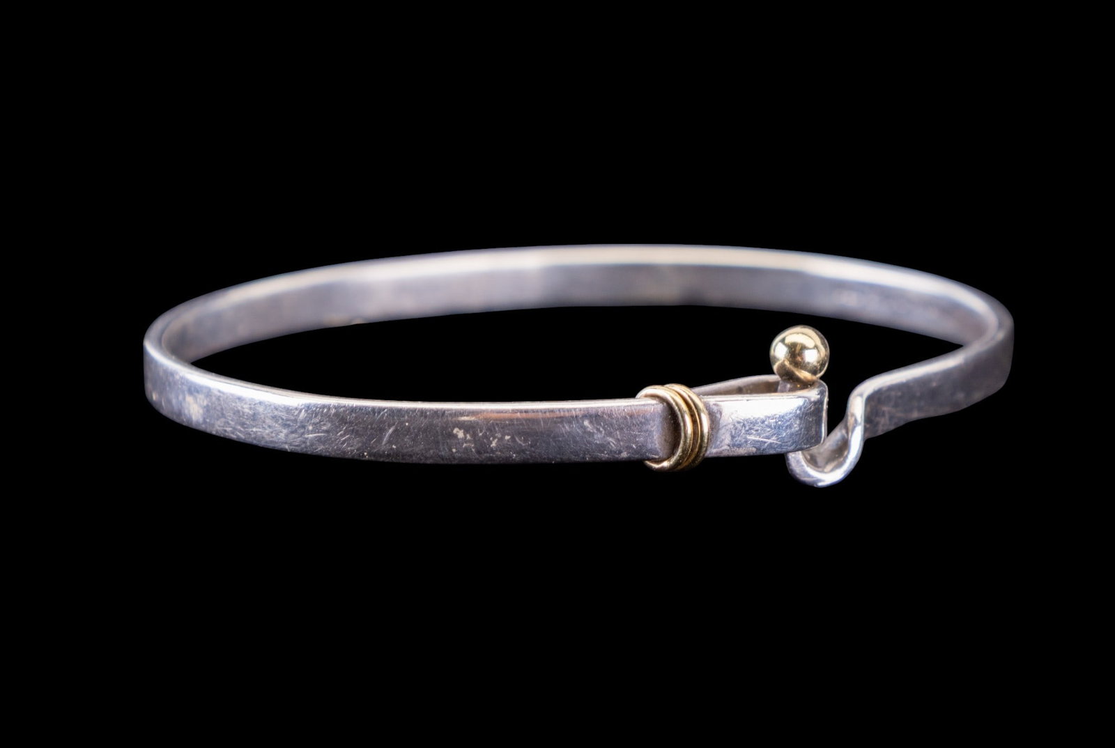 Tiffany & Co. Sterling Silver Bracelet 18K Accent: A Tiffany & Co. sterling silver bracelet with 18K gold accents, measuring approx. 2.5" in diameter. Item marked on inside of bracelet Tiffany & Co 925 750.