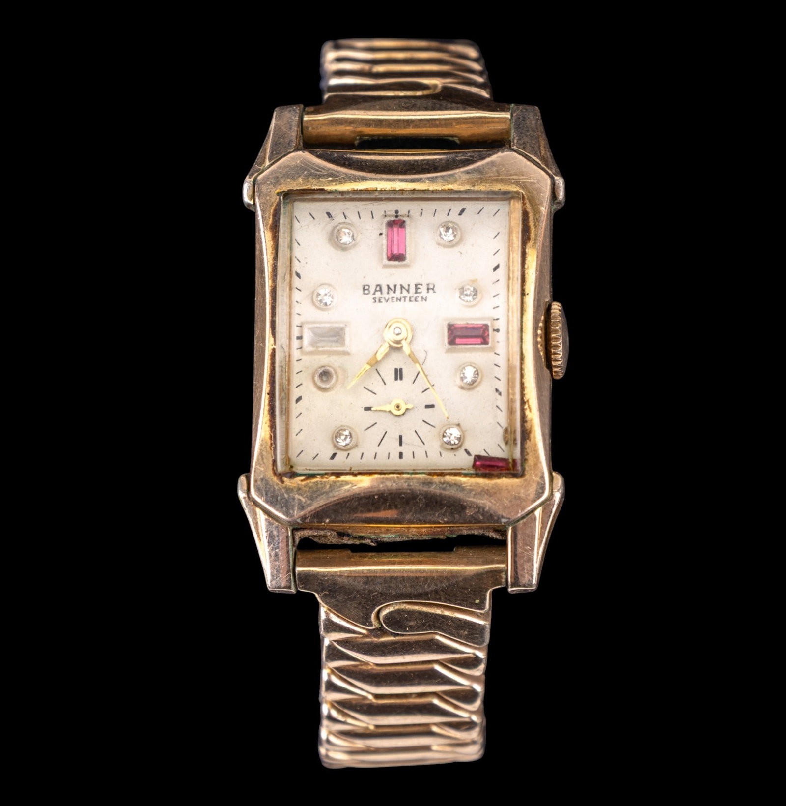 Banner 17 Jewel GF and RGP Vintage Watch: A banner 17 jewel watch with RGP bezel and 1/20 12k GF top band. Four pink rectangular stones on face with small diamond accents. One accent, one pink stone unhoused.