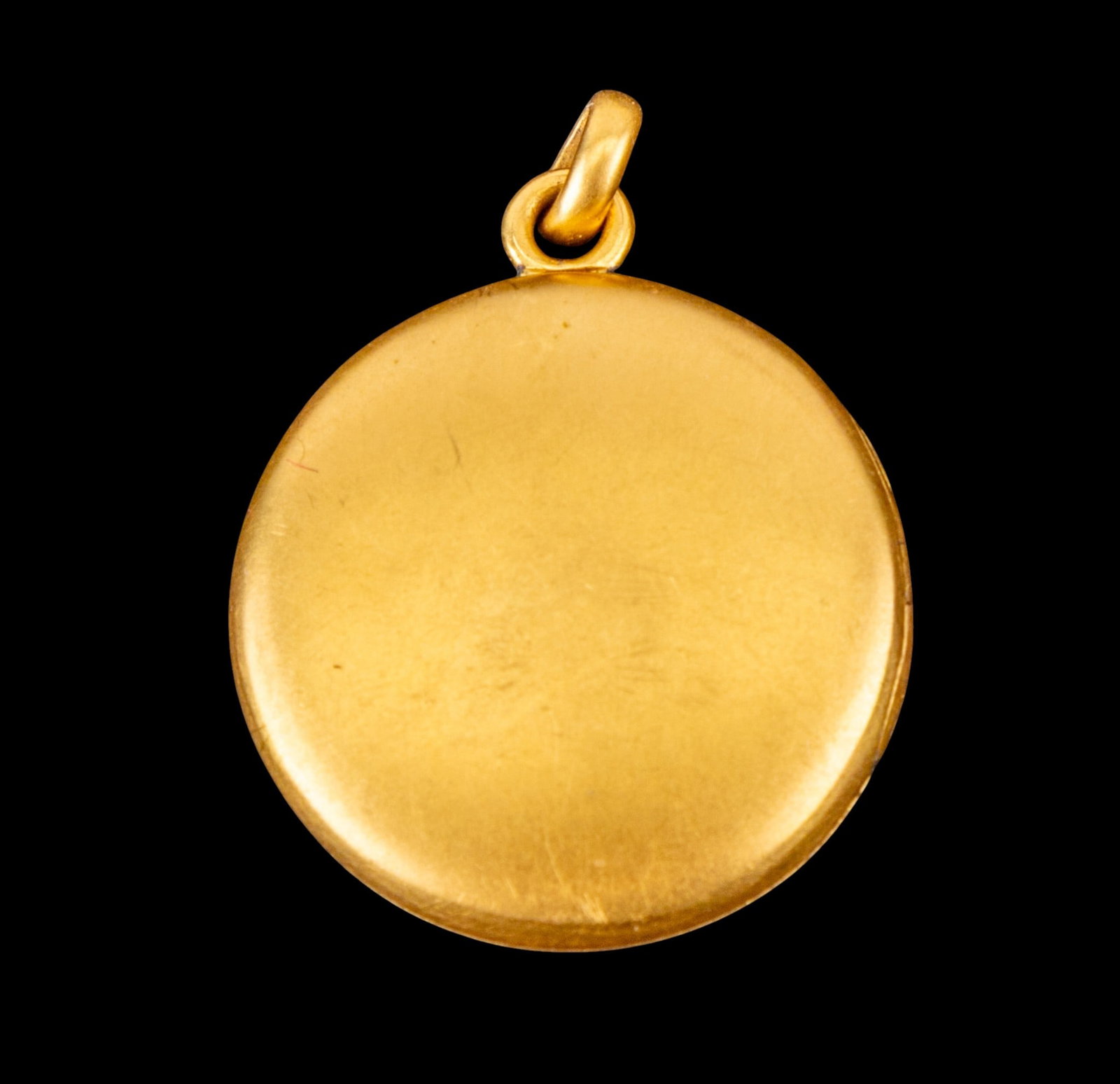 10k Yellow Gold Picture Locket Medallion: A marked 10k yellow gold plain picture locket medallion with glass inserts. Measuring 5/8th " diameter weighing approx. 2.32 grams. Panels in good condition.