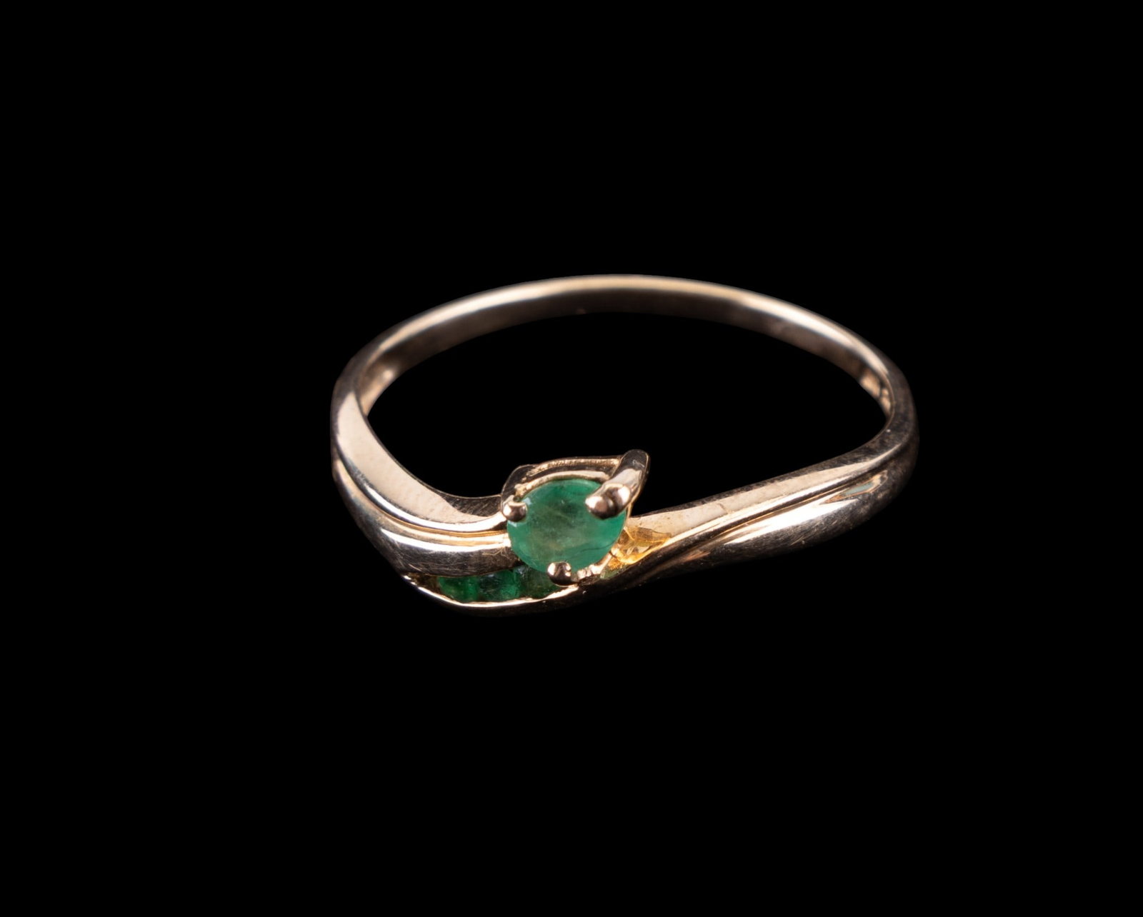 10K Gold Emerald Ring: 10k yellow gold ring with 4 seated emeralds. Size 9. Weight approx. 1.55 grams, marked "10K" along with a makers mark.