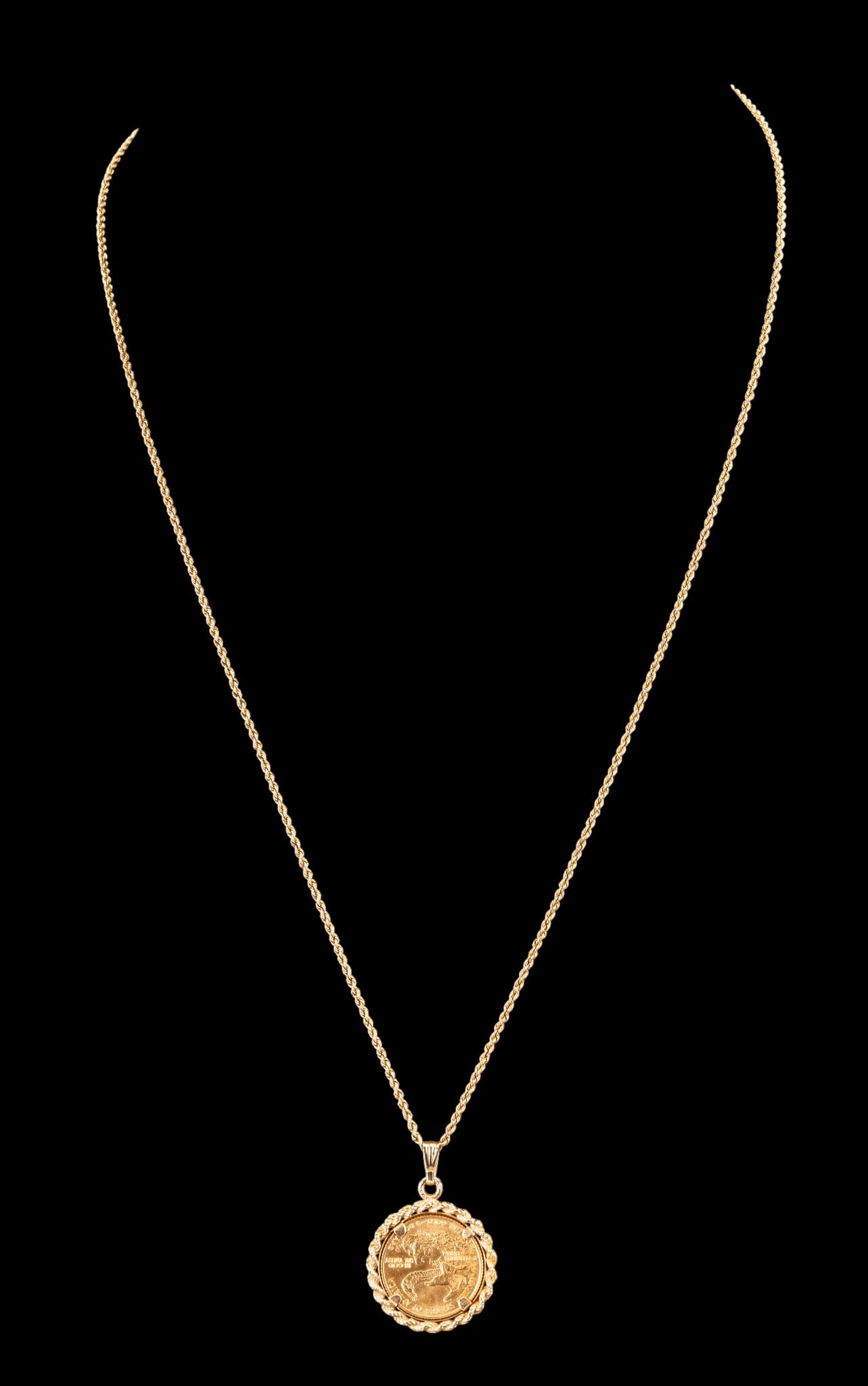 14K Gold Chain, Saint-Gaudens 1/10 oz Pendant: 14k gold chain paired with a Saint-Gaudens Double Eagle 1/10 oz .999 gold coin pendant. The coin is set within a yellow gold rope-style bezel. The total weight of the chain, pendant, and coin is 8.0 g